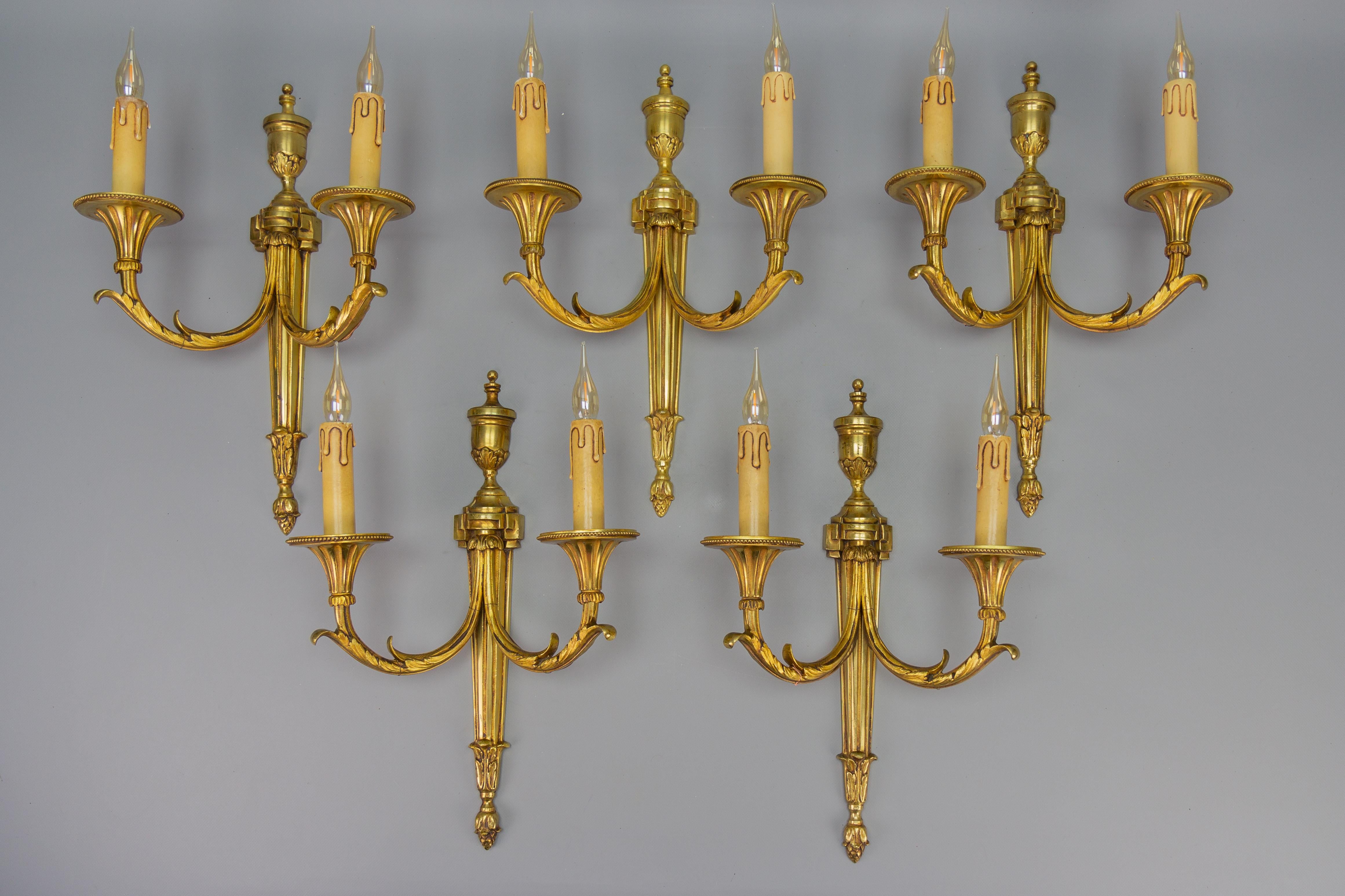 Large Neoclassical Style Bronze Double Arm Wall Sconce, France, ca. 1970s
One of five large French Neoclassical style bronze candelabra-form wall sconces with elegant urn finials and two arms adorned with acanthus leaves terminating in candlestick