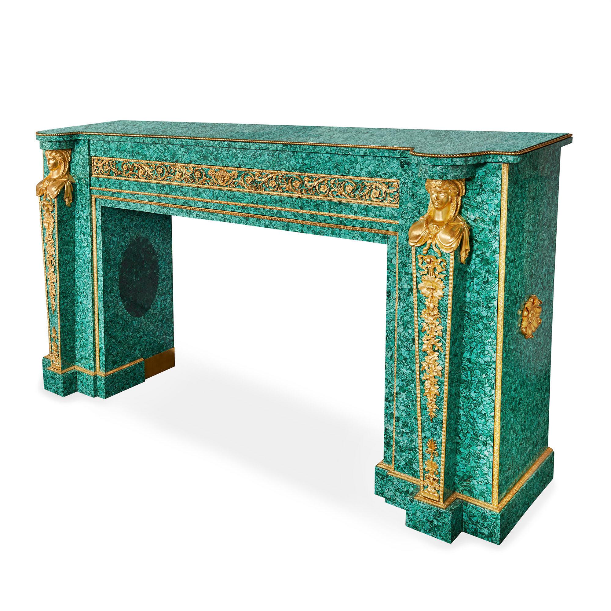 Large Neoclassical style gilt bronze and malachite fireplace
French, 20th century
Measures: Height 124cm, width 218cm, depth 58cm

Crafted from the timeless combination of malachite and gilt bronze, this monumental fireplace is a striking expression