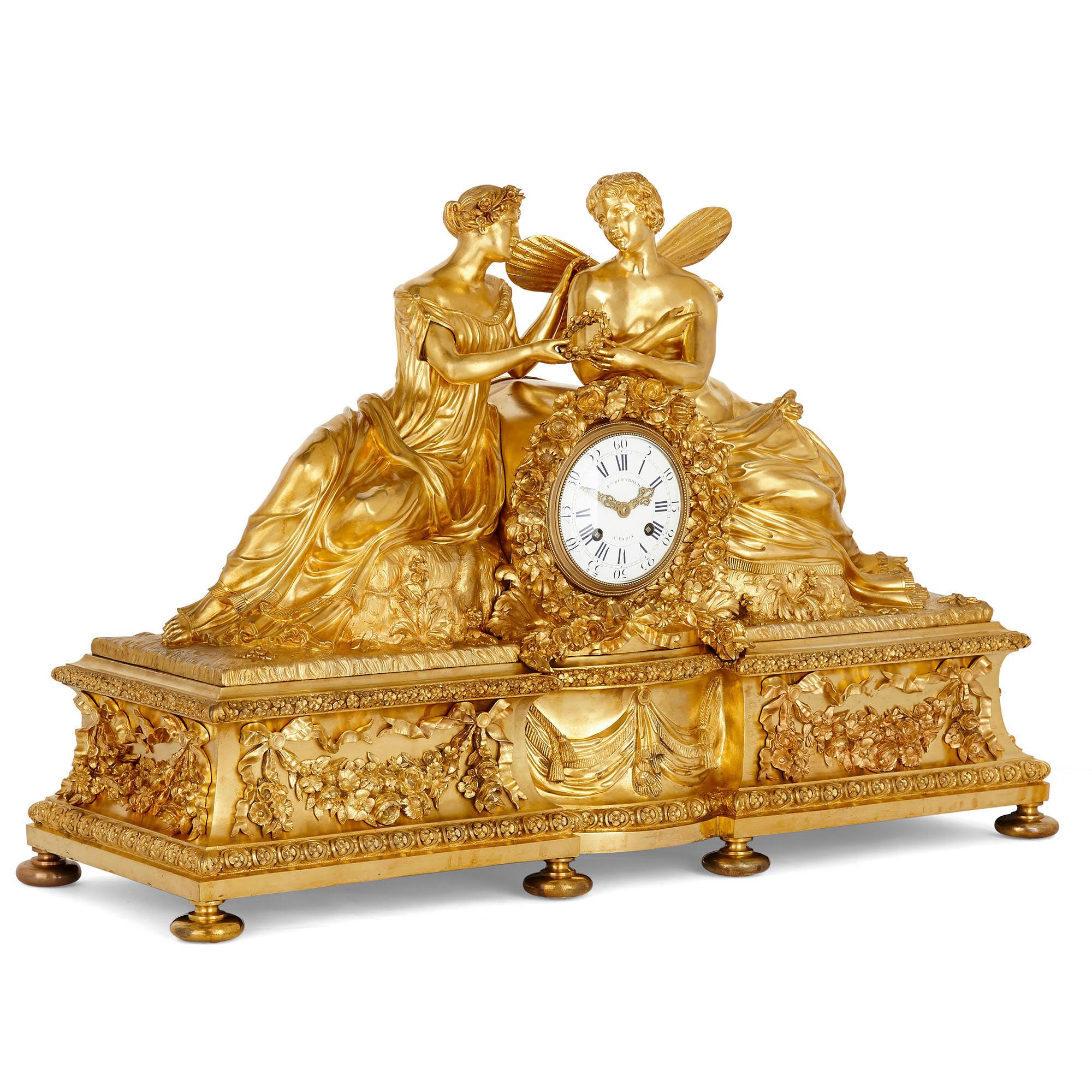 Large neoclassical style gilt bronze mantel clock with cupid and psyche
French, 19th century
Measures: Height 54cm, width 80cm, depth 30cm

This beautiful mantel clock features a case wrought entirely from gilt bronze in the ornate Louis XVI
