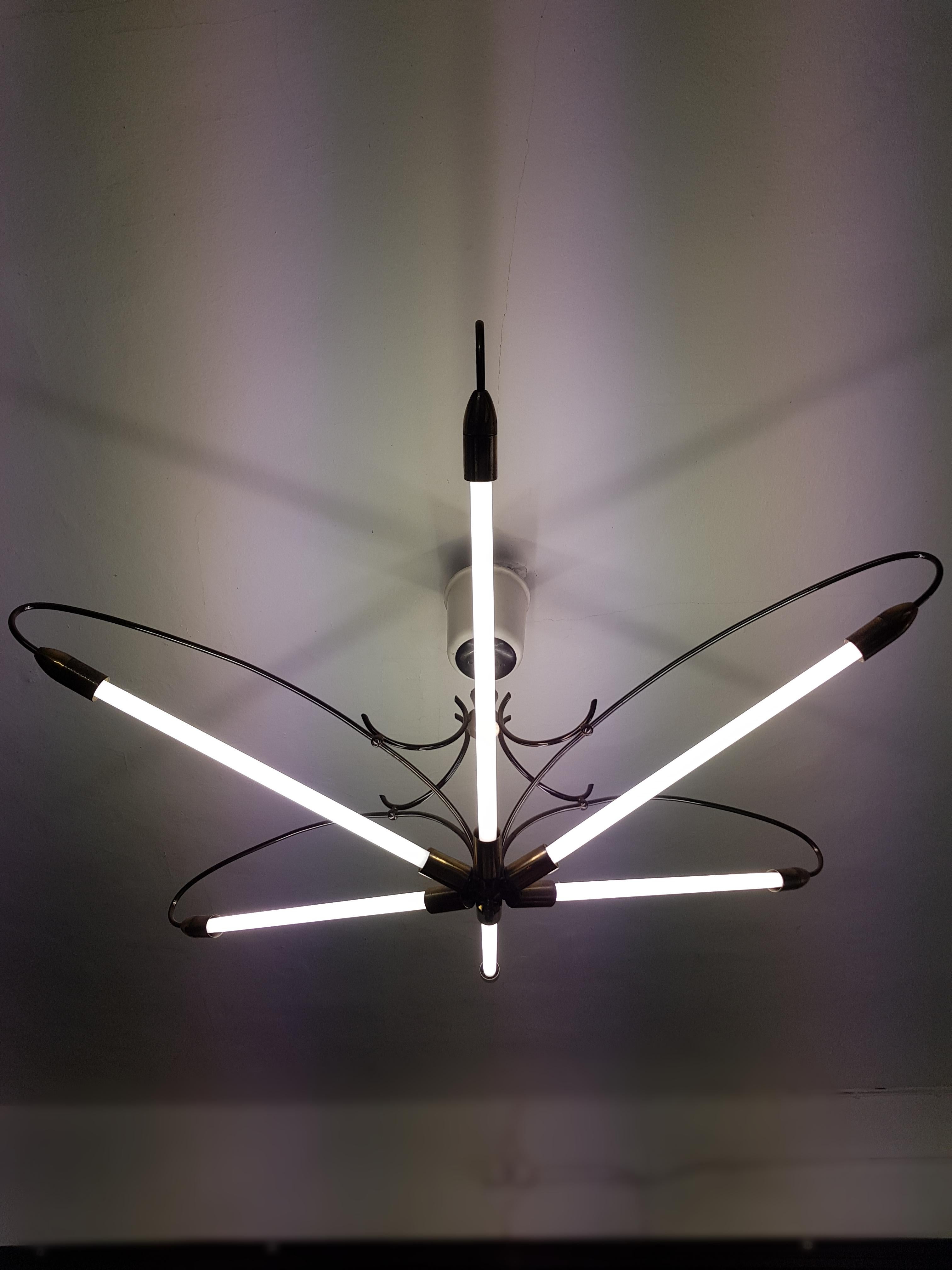 
Measures: Total height 75 cm, height without chain 75 cm, diameter 155 cm, weight (approximately) 10 kg.

Number of lights: Five fluorescent tube lights

Large neon light tube Bauhaus pendant chandelier 1950s Vintage fluorescent lamp.