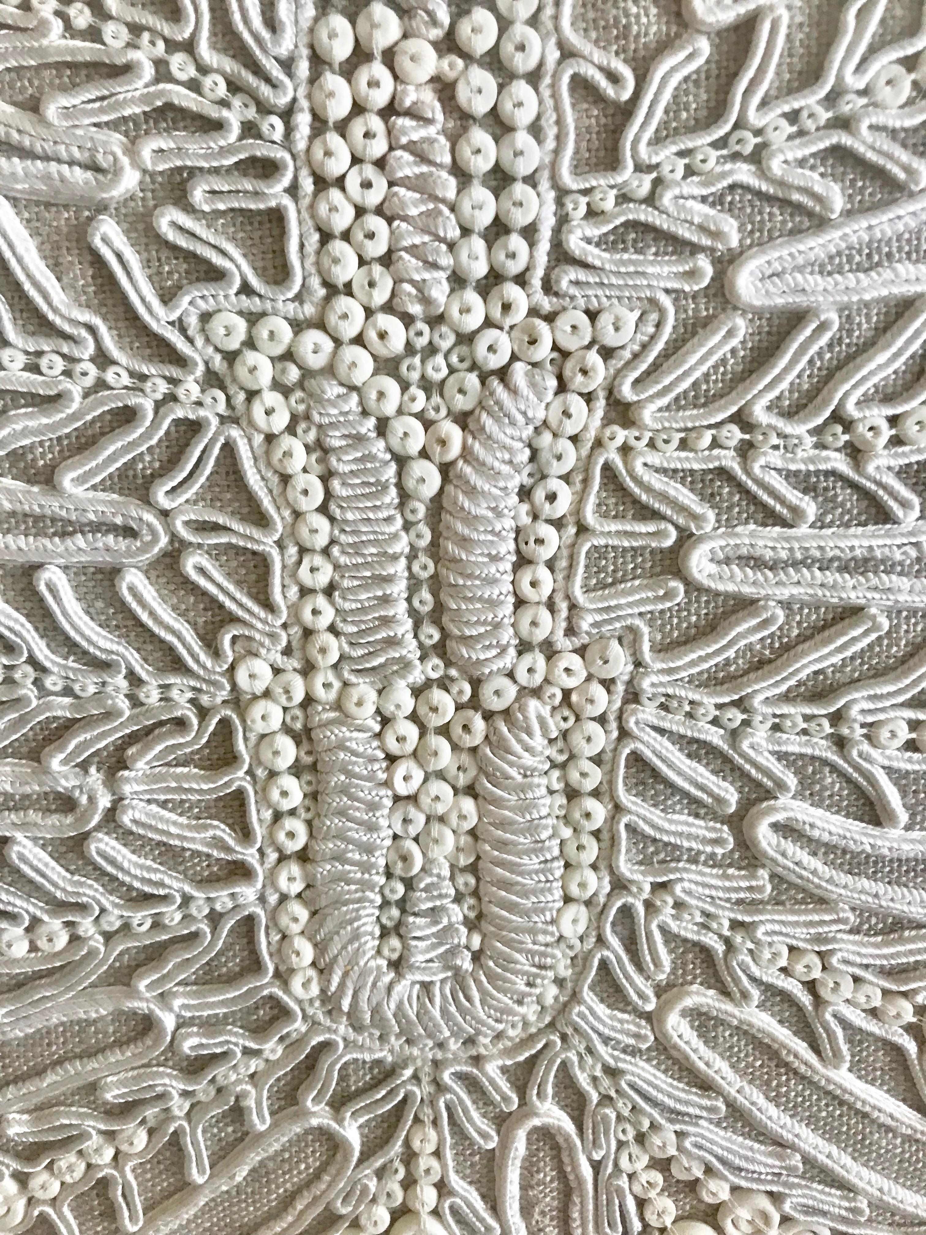 Beautiful large framed embroidery having white heavy yarn in an abstract intricate design against taupe muslin, matted and framed in white.