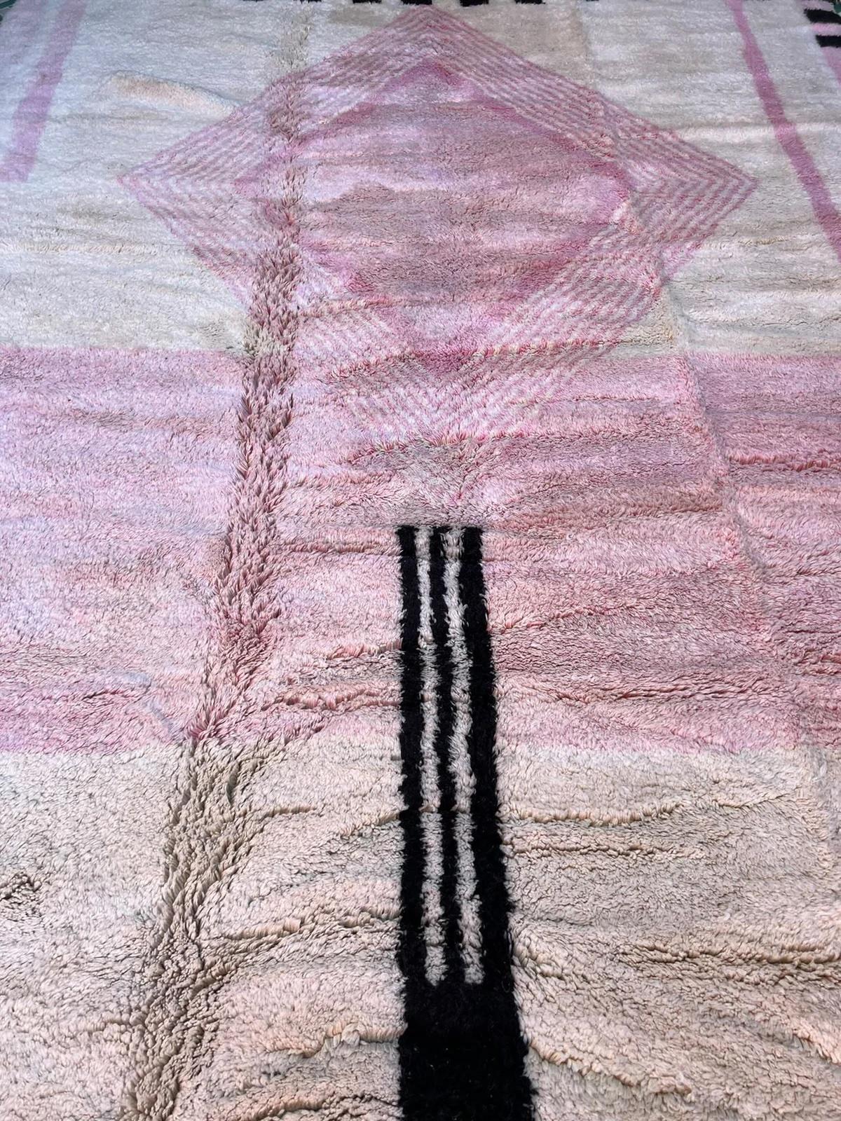 This large cream handwoven Moroccan rug was made by hand by skilled artisans in the Atlas Mountains using the highest quality M'Rirt wool. It is impressive in both size and design, and is the perfect luxury statement piece for any room. It features