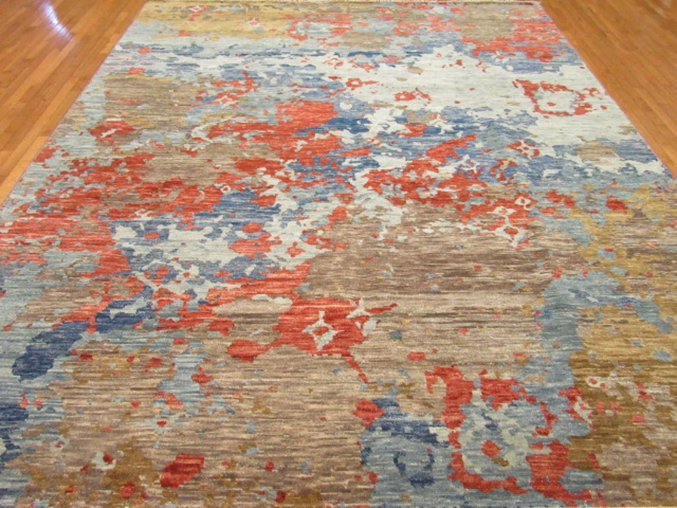 This is a large new handmade rug from India. It has a modern and contemporary design for those who desire something different. It is made with wool and stabile dyes. It measures 9' 3''x 12'.