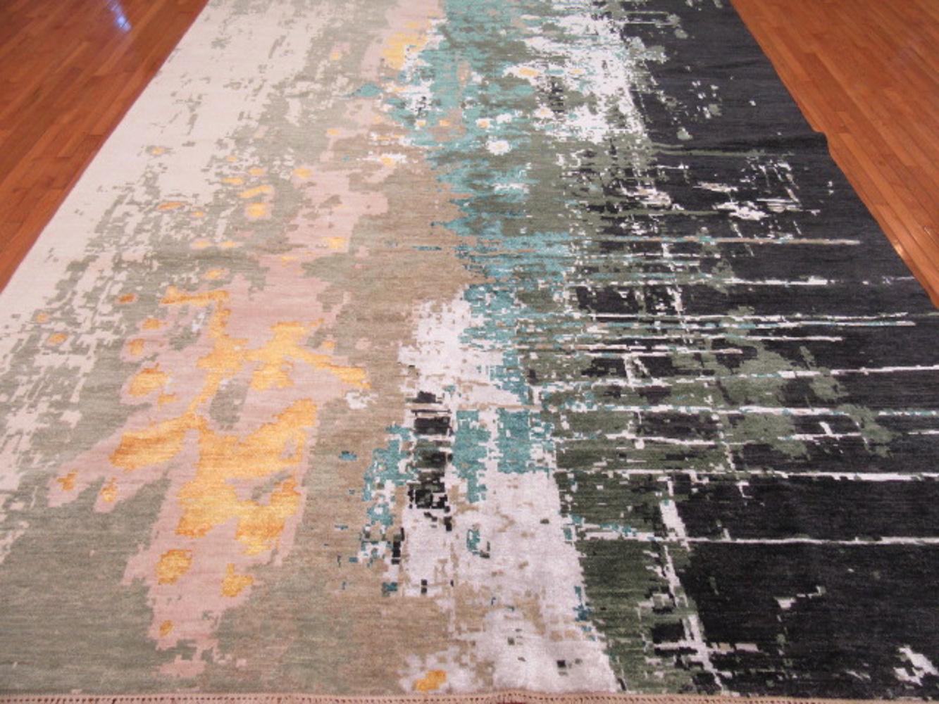 This is a large new handmade rug from India. It has a modern and contemporary design for those who desire something different. It is made with wool, bamboo silk and stabile dyes. It measures 9' x 12'.