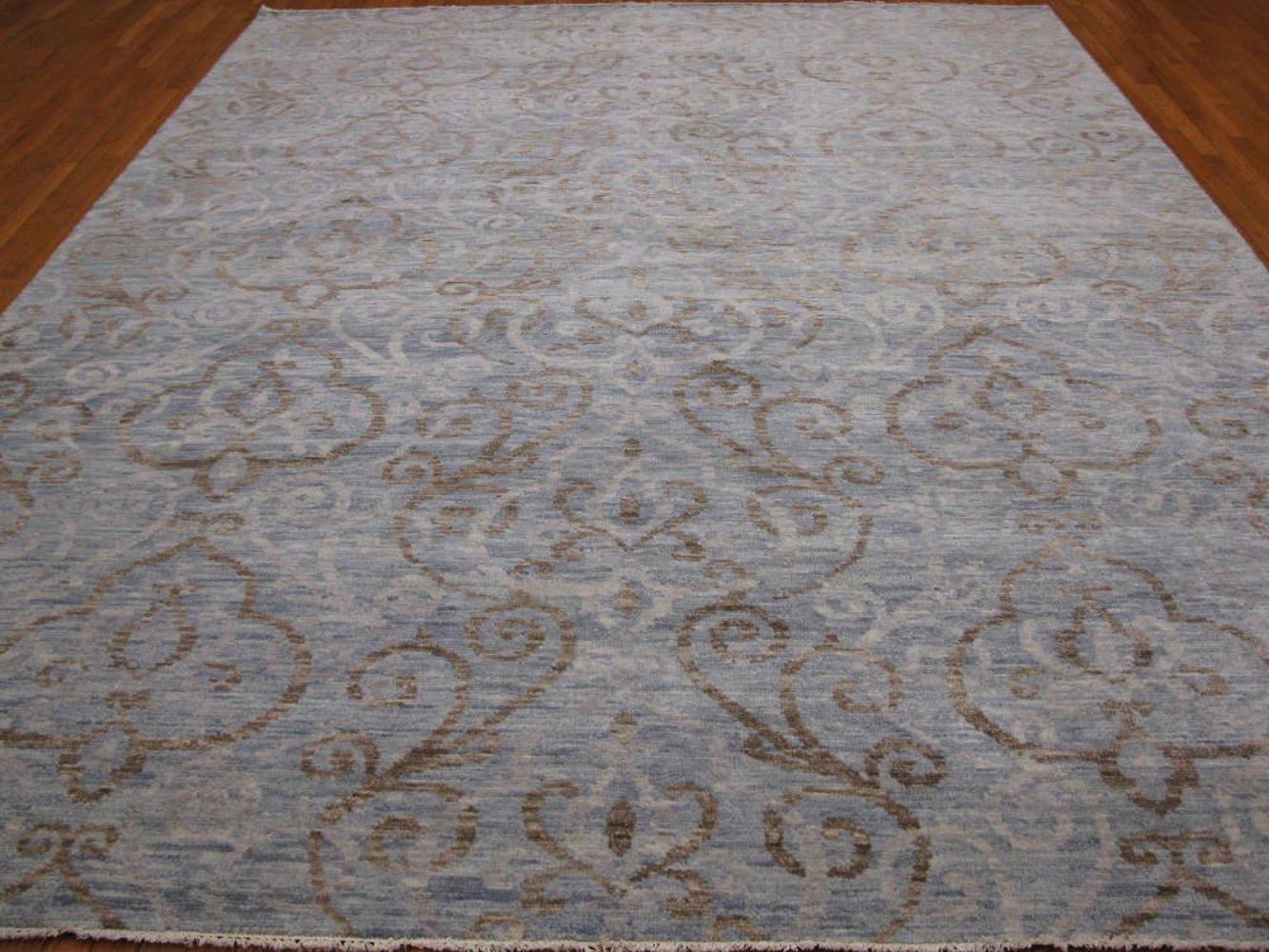 This is a large new handmade rug from India. It has a modern and contemporary design for those who desire something different. It is made with wool and stabile dyes. It measures: 9' x 12'.