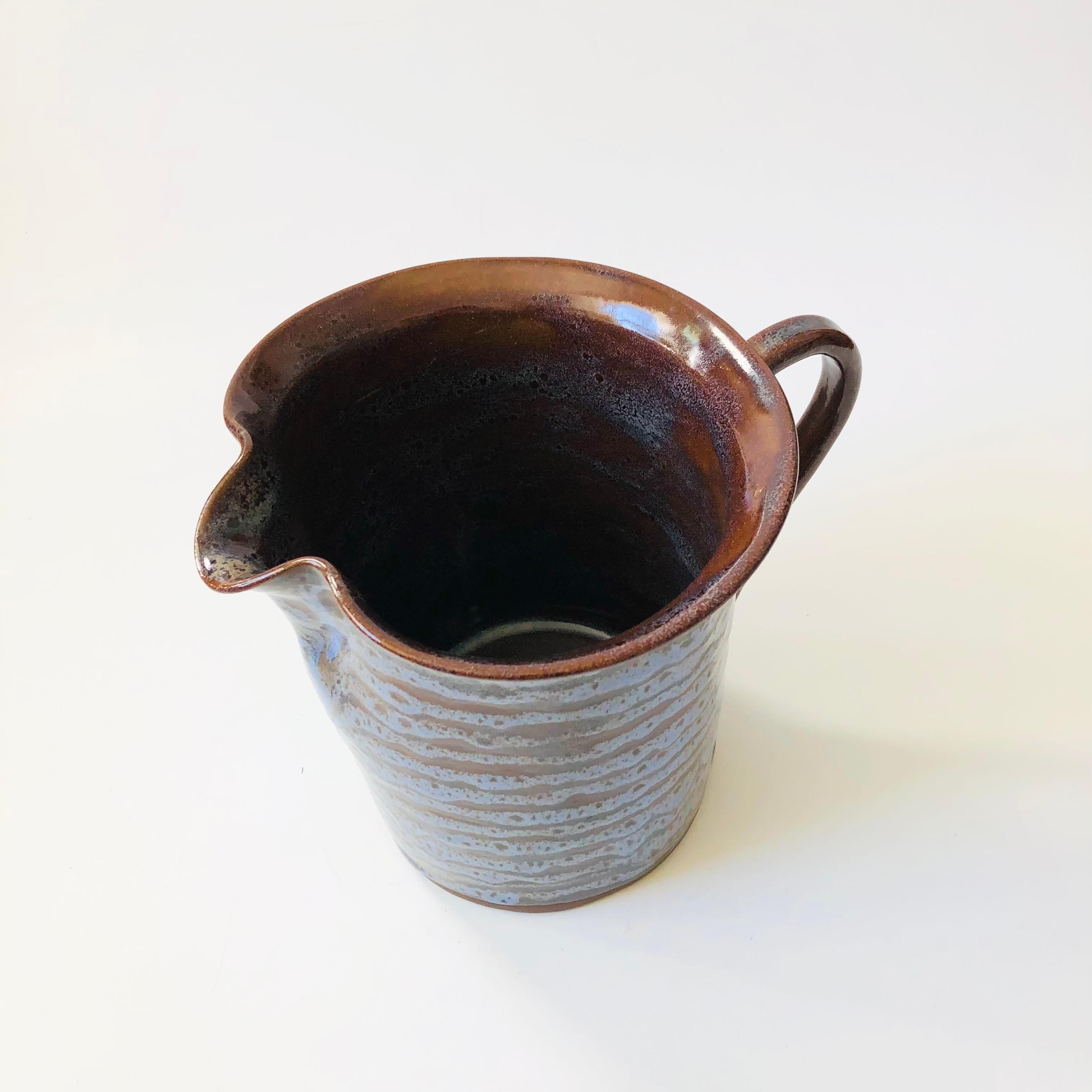 A vintage studio pottery pitcher by Northern California pottery, Niels Frederiksen (1917 - 2005).
Nice large size, finished in blue and brown glazes. Signed on the base.

