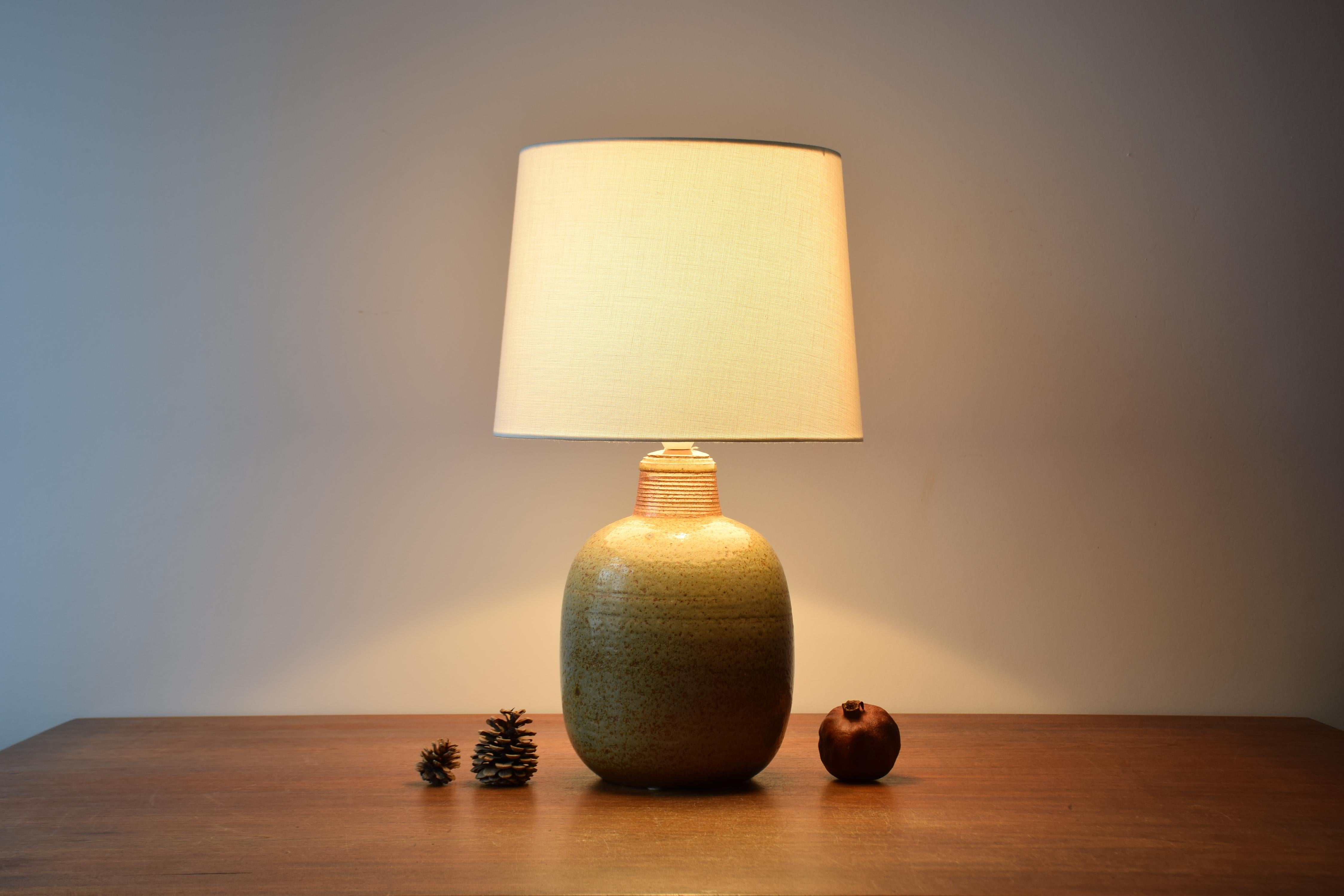 Rare very large table lamp designed by Nils Kähler and made by Herman A. Kähler´s ceramic workshop in Denmark ca 1960s. The beige glaze is slightly greenish and very vivid with darker elements.

Included is a new lampshade designed and made in