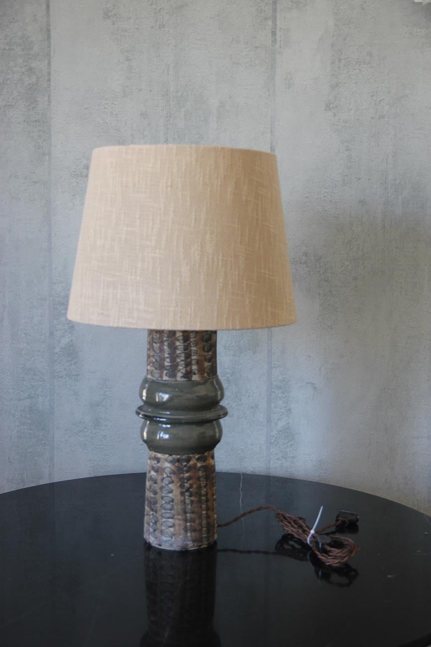 This beautiful vintage table lamp, designed by the renowned Nils Kähler for his family workshop, HAK Kähler, in Denmark during the 1960s, exudes timeless charm and craftsmanship. Its distinctive conical shape is both elegant and eye-catching,