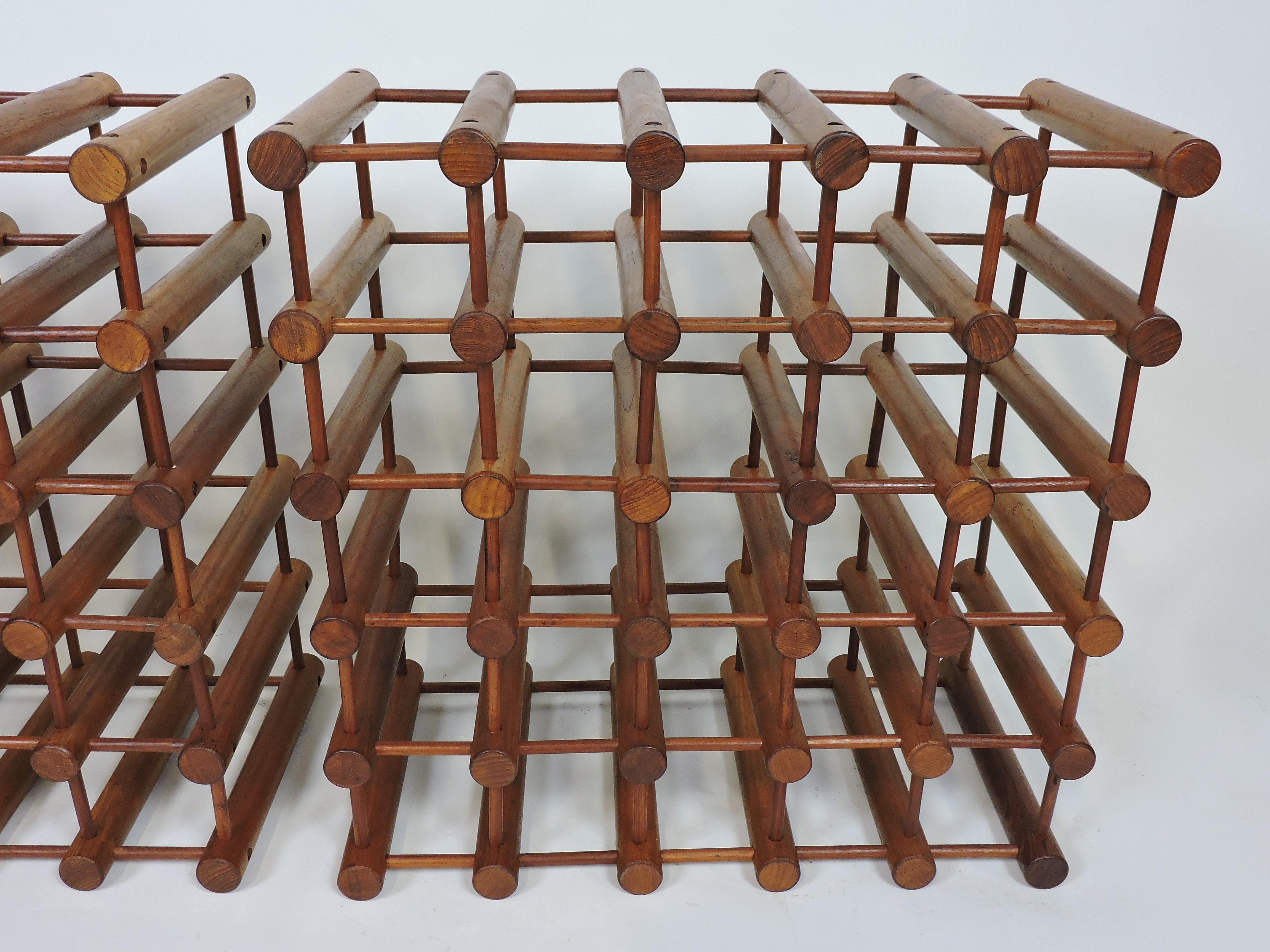 Beautiful Danish teak modular wine rack designed by Richard Nissen and made in Denmark by Langaa. This rack has an ingenious design consisting of solid teak pegs and dowels which can be taken apart and reconfigured in any way that you want. This is