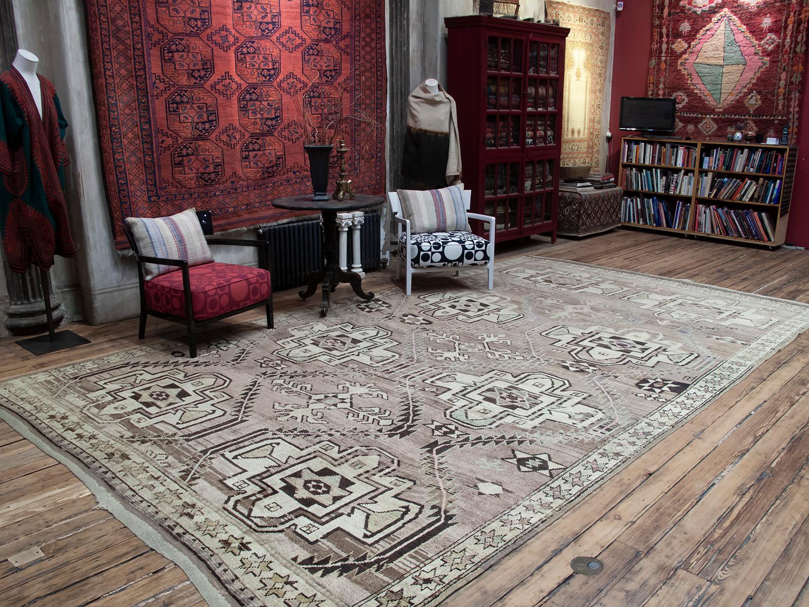 A large tribal carpet from Northeast Turkey, on the border with the Caucasian region. The large scale star or shield design is familiar from Kurdish and Caucasian carpets and is rendered in a whimsical manner we expect from tribal weavers. An