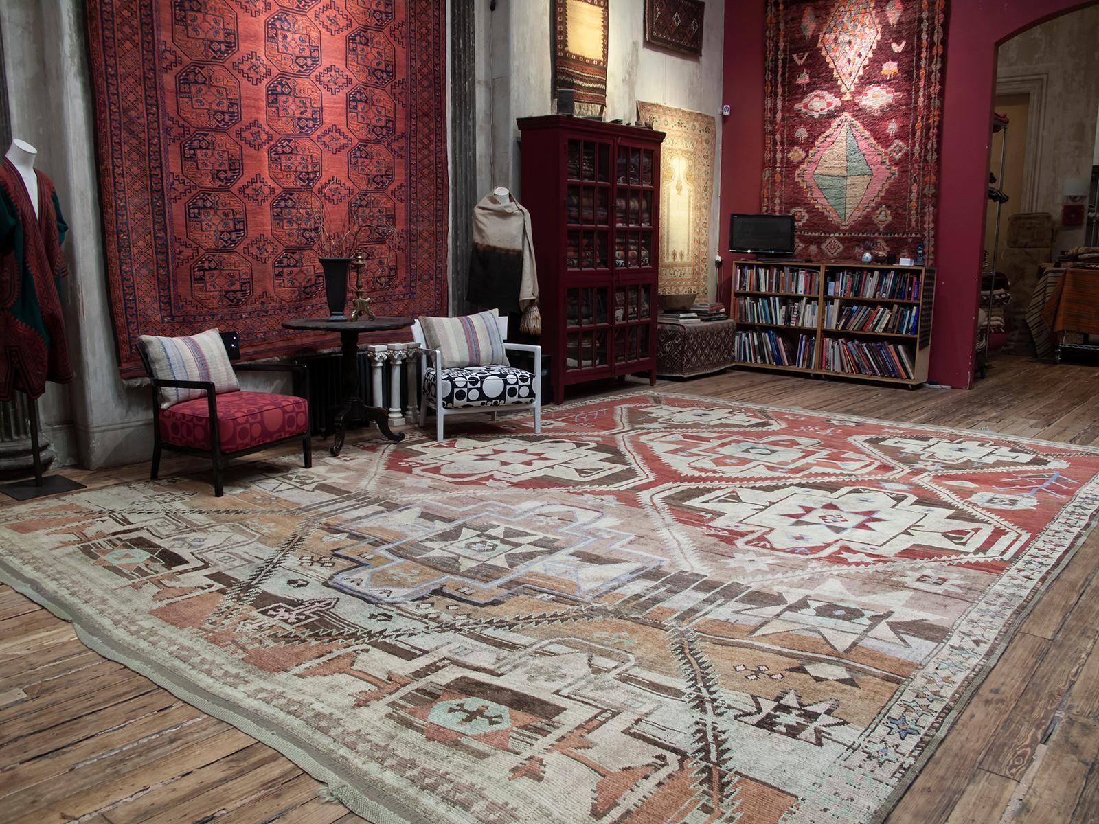 An unusually large tribal carpet from Northeast Turkey, on the border with the Caucasian region. The large scale star or shield design is familiar from Kurdish and Caucasian carpets and is rendered in a whimsical manner we expect from tribal