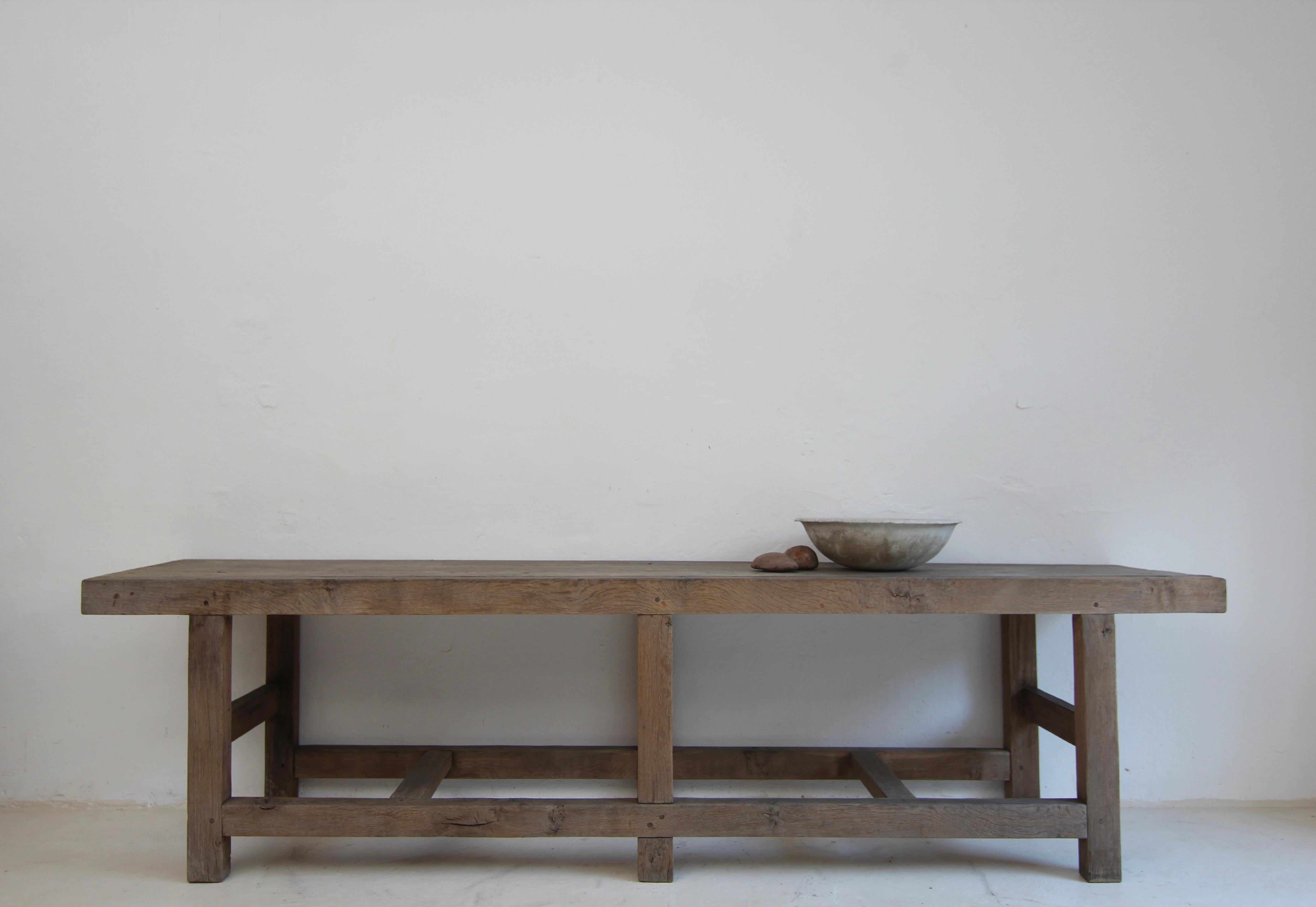 A large double sided console table or drapers table made of oak. Outstanding purist design combined with traditional craftsmanship and beautiful slightly weathered patina.

Rectangular table frame with web joints consisting of oak beams connected
