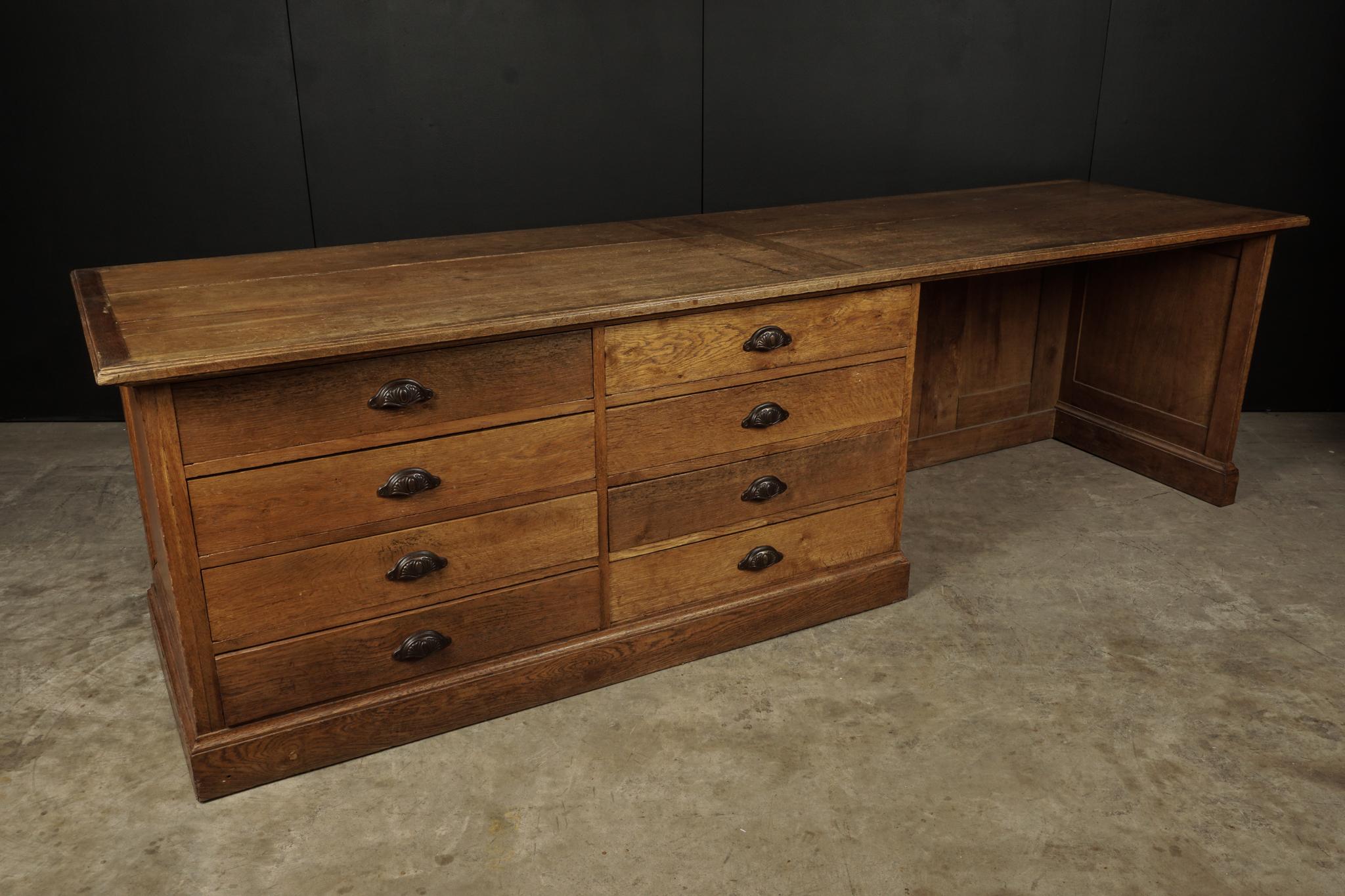 Large oak counter with drawers from France, circa 1930. Solid oak construction with eight drawers.