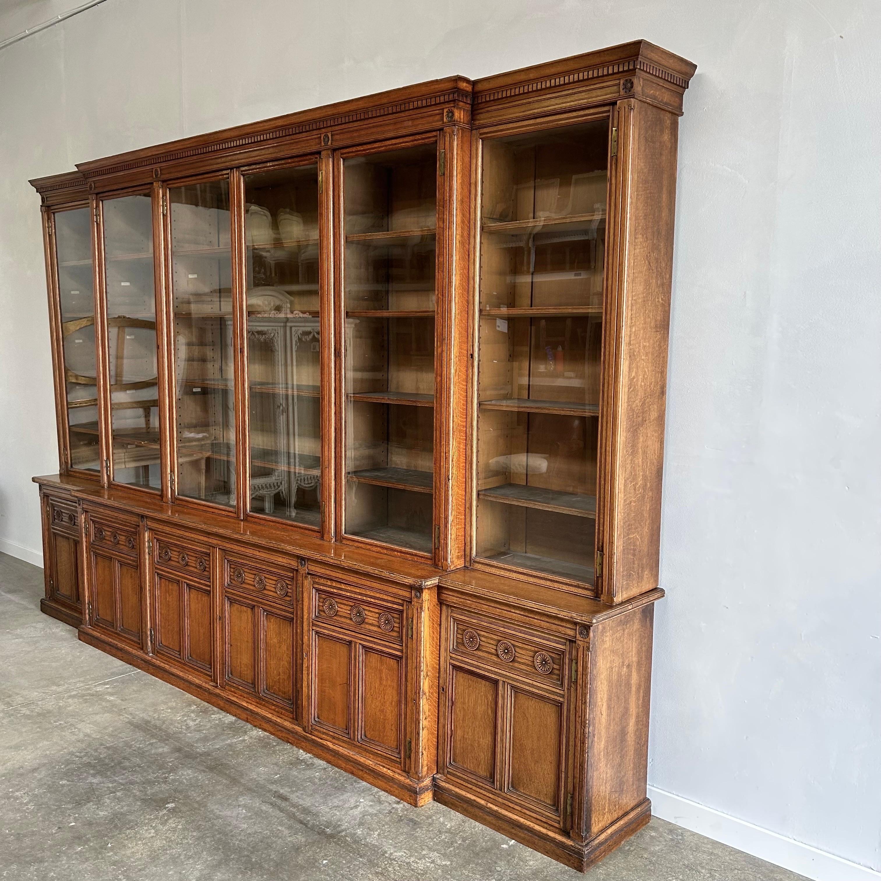 Large Antique oak cabinet bookcase display in the Gustavian Style.
Overall Size: 144”w x 20”d x 94”h 
Bottom cabinet stands at 31” in height, the top bookcase portion is 63