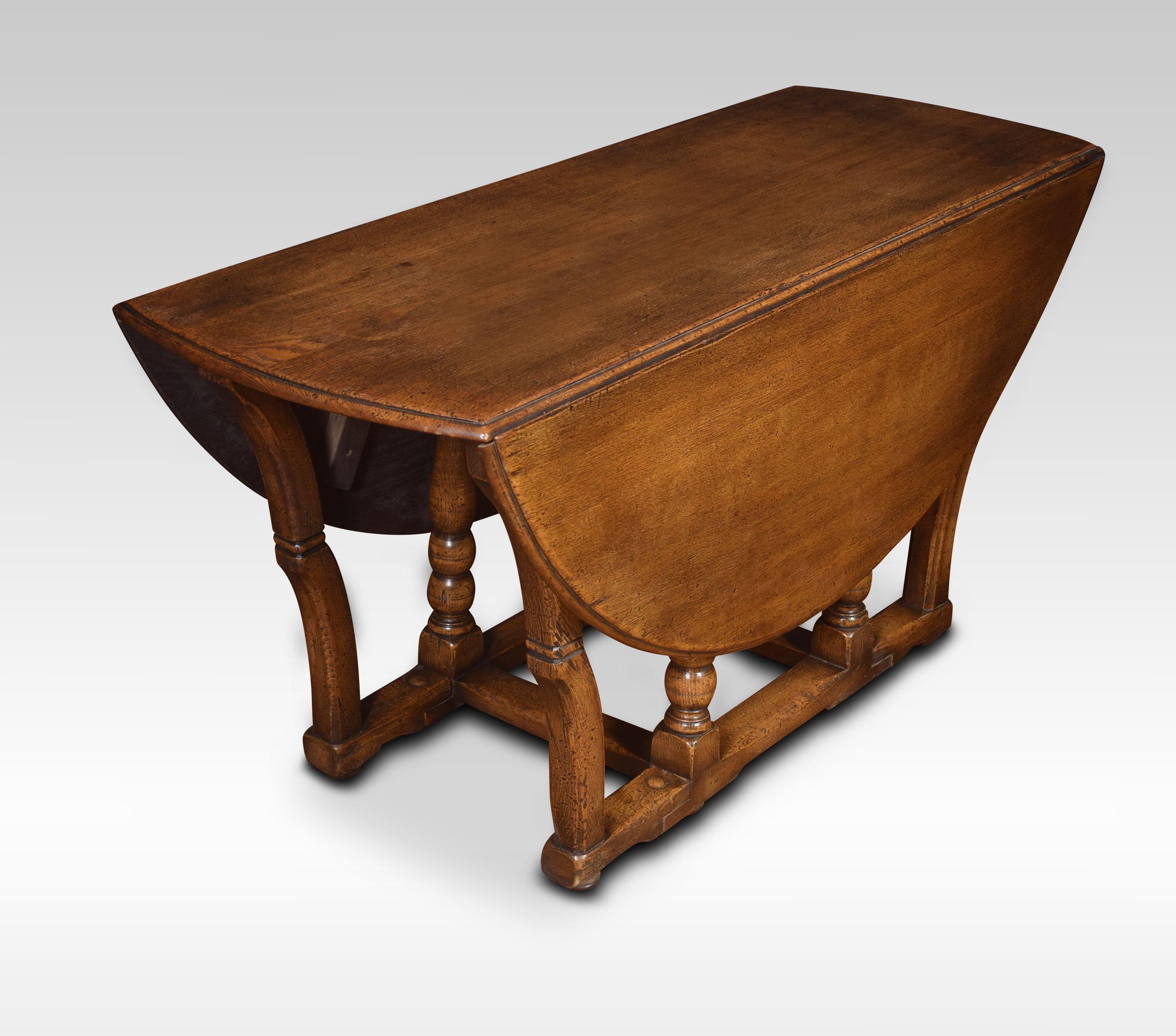 Large oak gateleg dining table, having a circular drop-leaf top raised up on turned supports and shaped gatelegs, united by stretchers.
Dimensions:
Height 29 inches
Width 22 inches when up 59.5
Depth 59.5 inches.