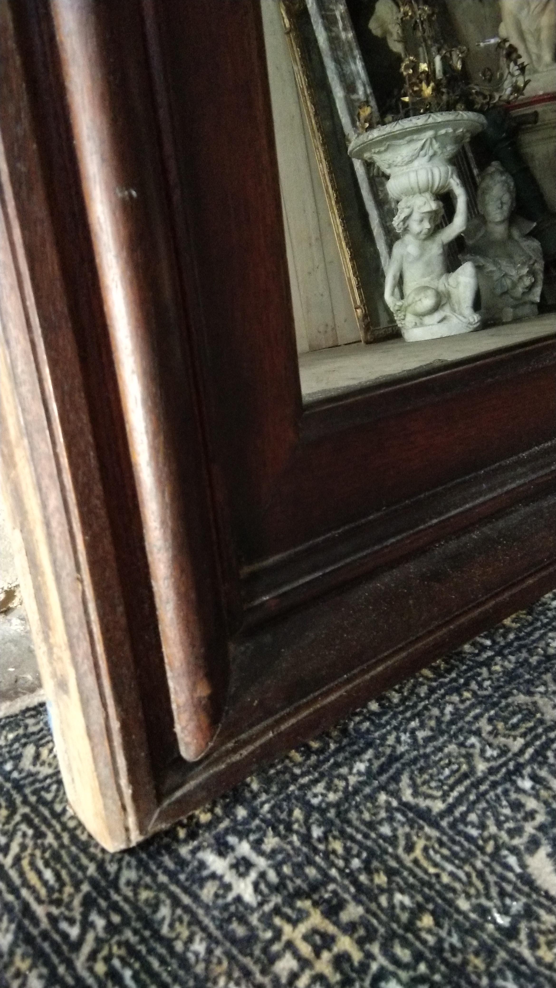 A heavy and imposing French rectangular mirror with a wide frame. Can be a floor mirror because of the huge size. The glass is original, circa 1880. Measures: The frame is 15 cm.