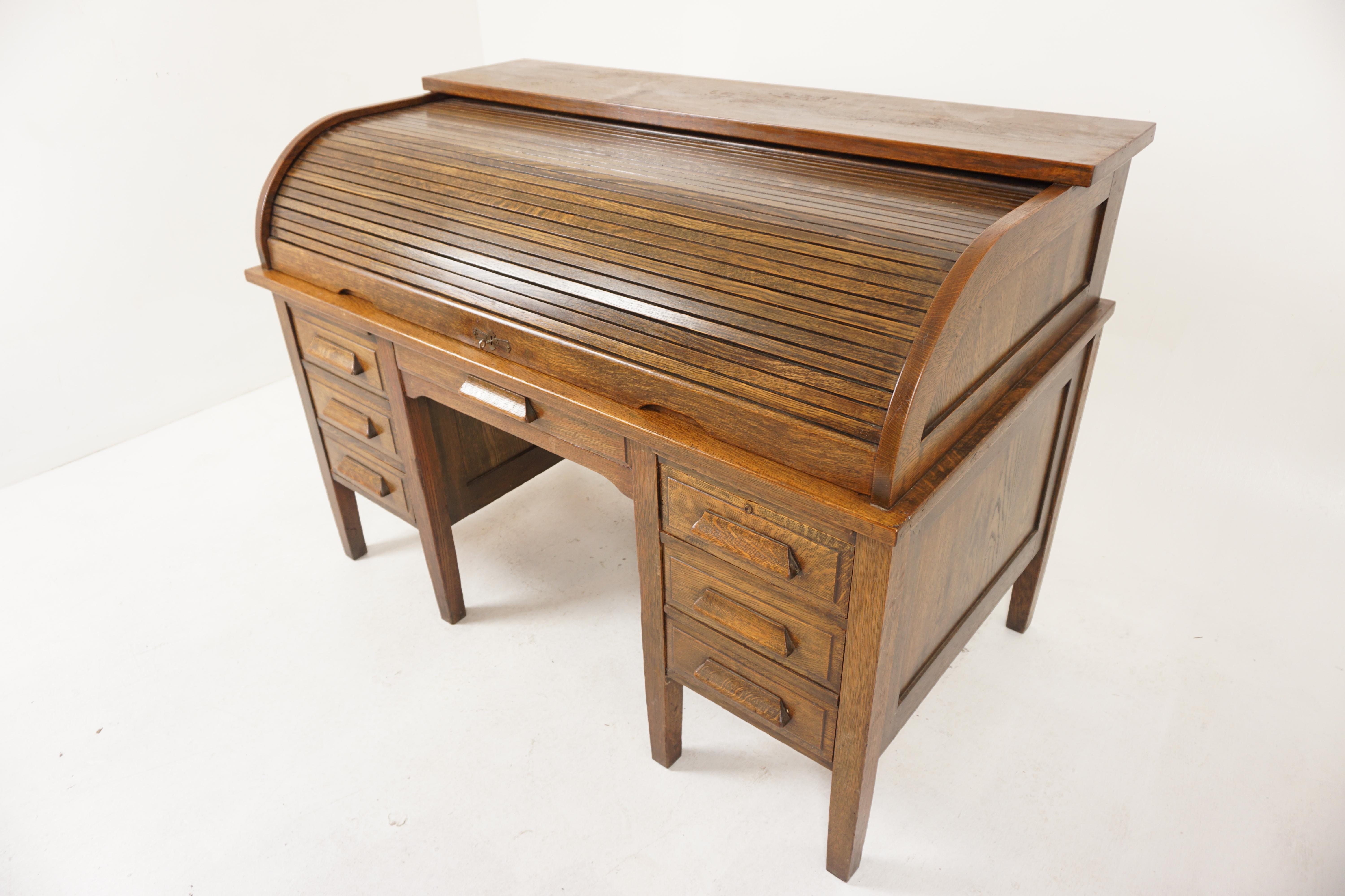 Large Oak Panelled Roll Top Desk, Scotland 1920, H1182

Scotland 1920
Solid oak 
Original Finish
Rectangular moulded top
With tambour front
Opening to reveal numerous drawers and pigeon holes
The front with three drawers to the left and two to the