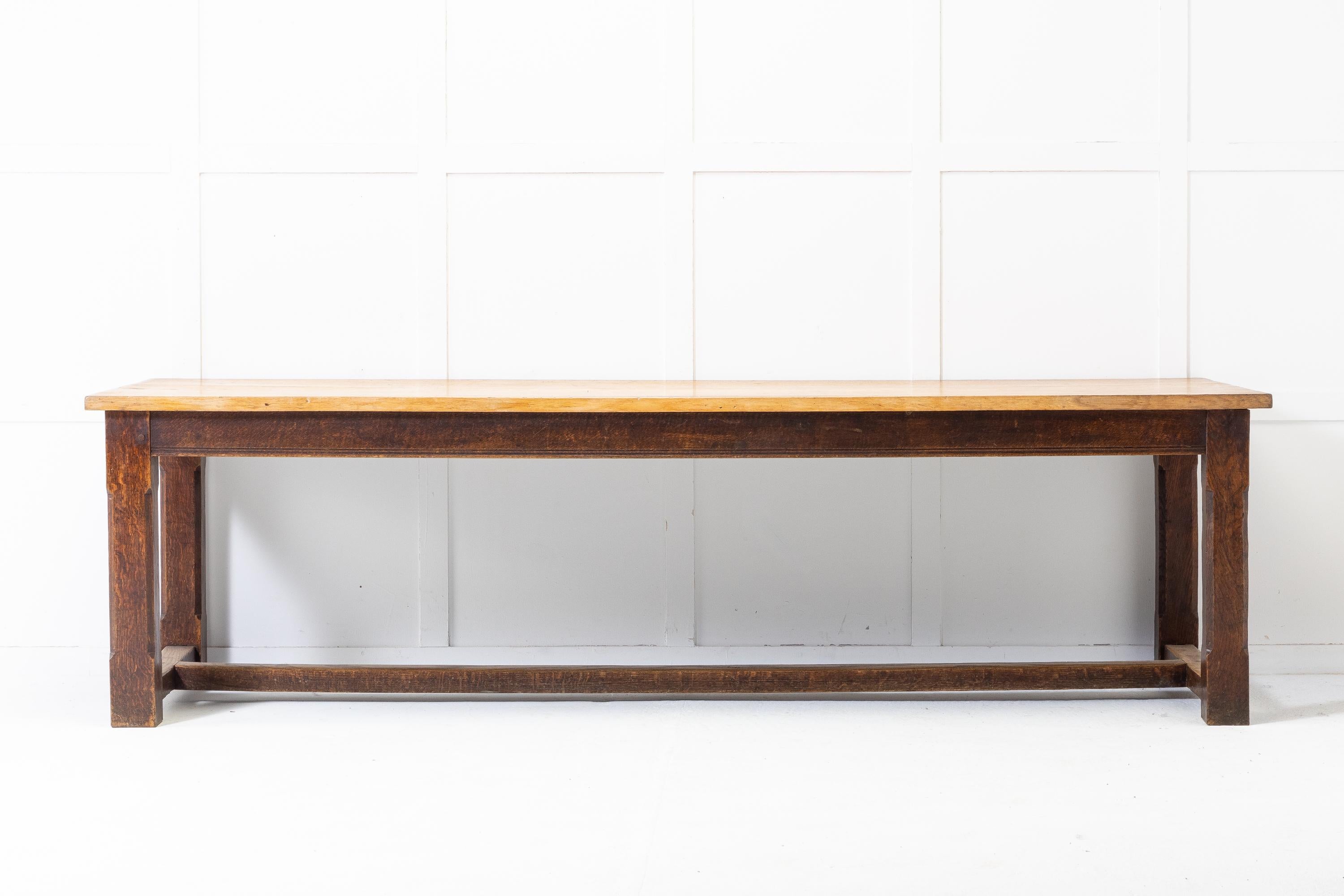 A good scale refectory table crafted from oak with large rectangular, stripped plank top. Raised on square shaped legs with chamfered edges, conjoined by a large central stretcher. Circa 1910.
 