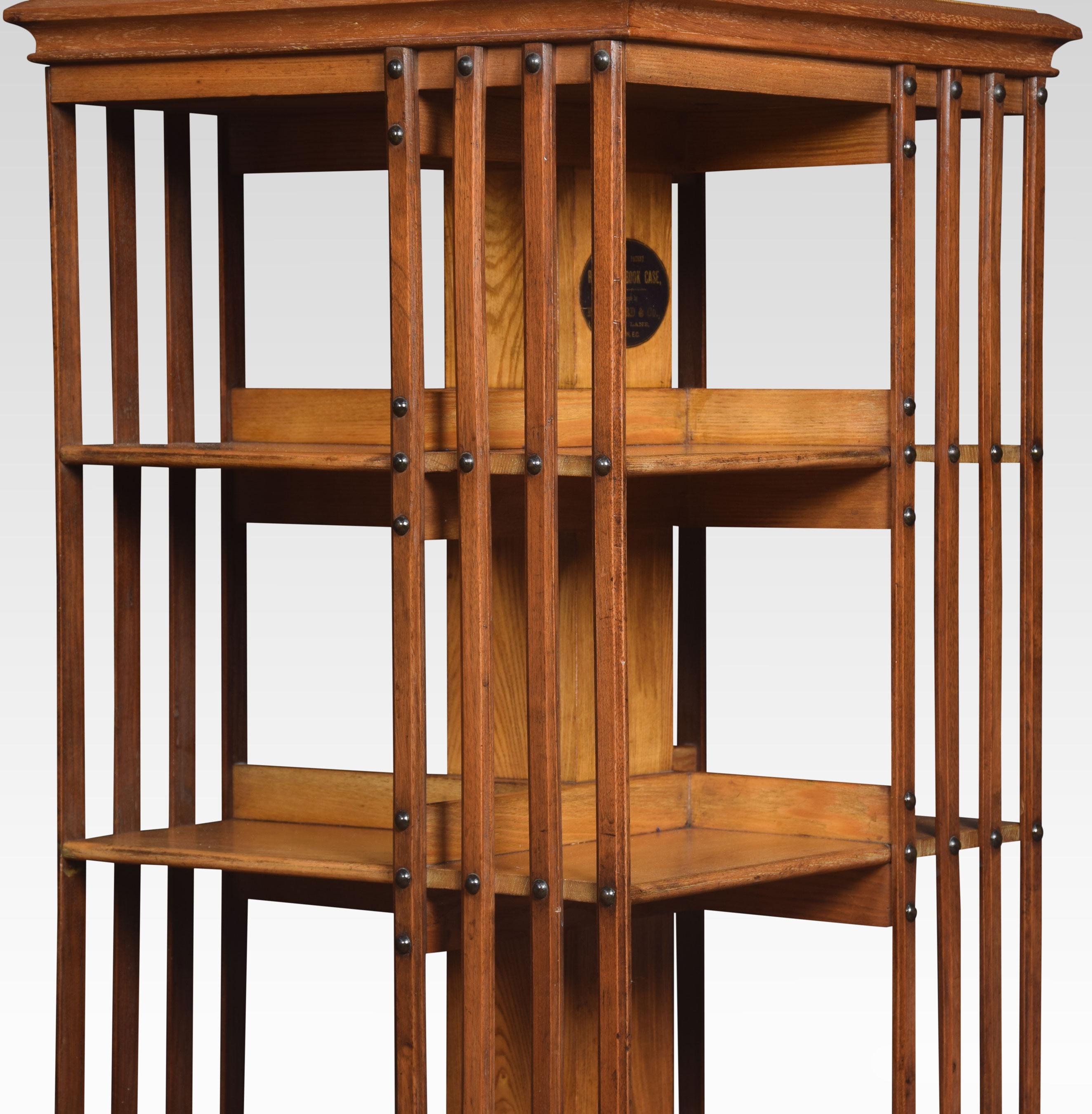 Large oak revolving bookcase the square molded top above four tiers with an arrangement of shelves raised up on cruciform base terminating in ceramic castors.
Dimensions:
Height 54 inches
Length 20 inches
Width 20 inches.