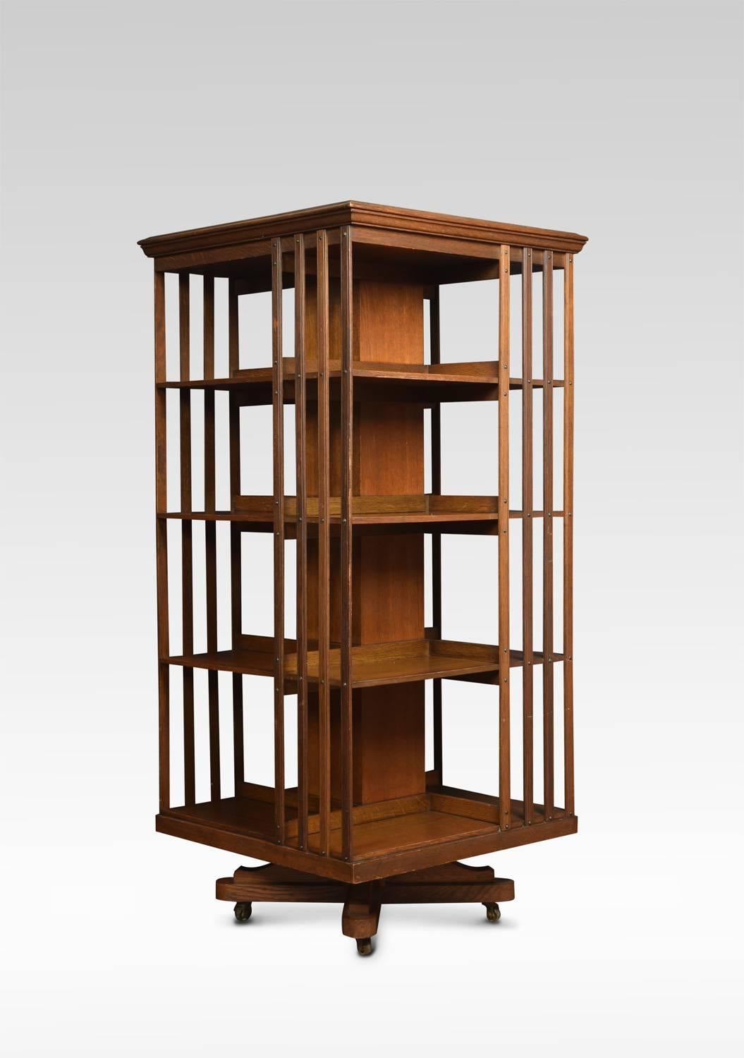 Oak revolving bookcase the square top above four tiers with an arrangement off shelves raised up on cruciform base with castors
Dimensions
Height 52 inches
Width 24 inches
Depth 24 inches.