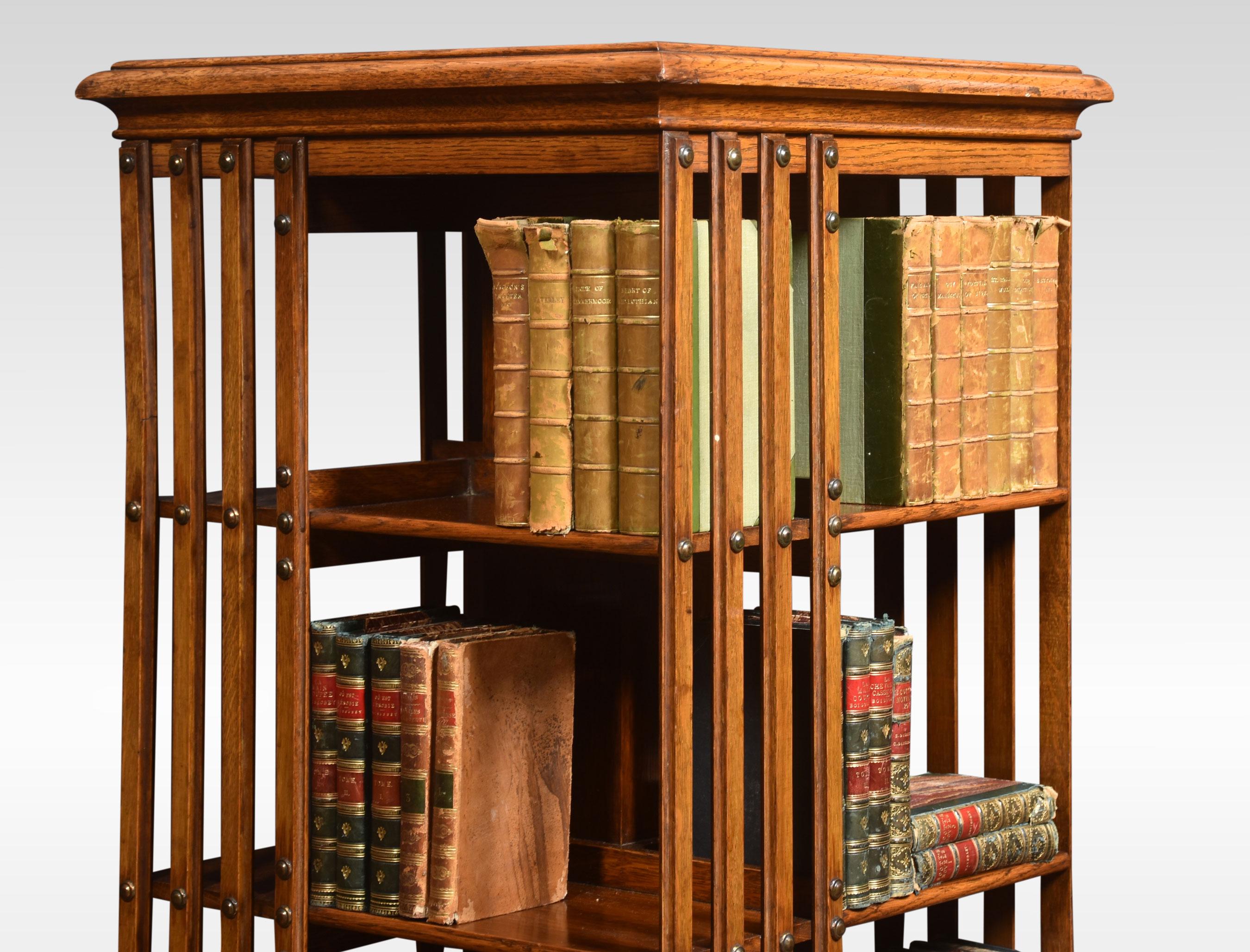 Large oak revolving bookcase the square molded top above four tiers with an arrangement of shelves raised up on cruciform base terminating in ceramic castors.
Dimensions
Height 50.5 inches
Width 20 inches
Depth 20 inches.