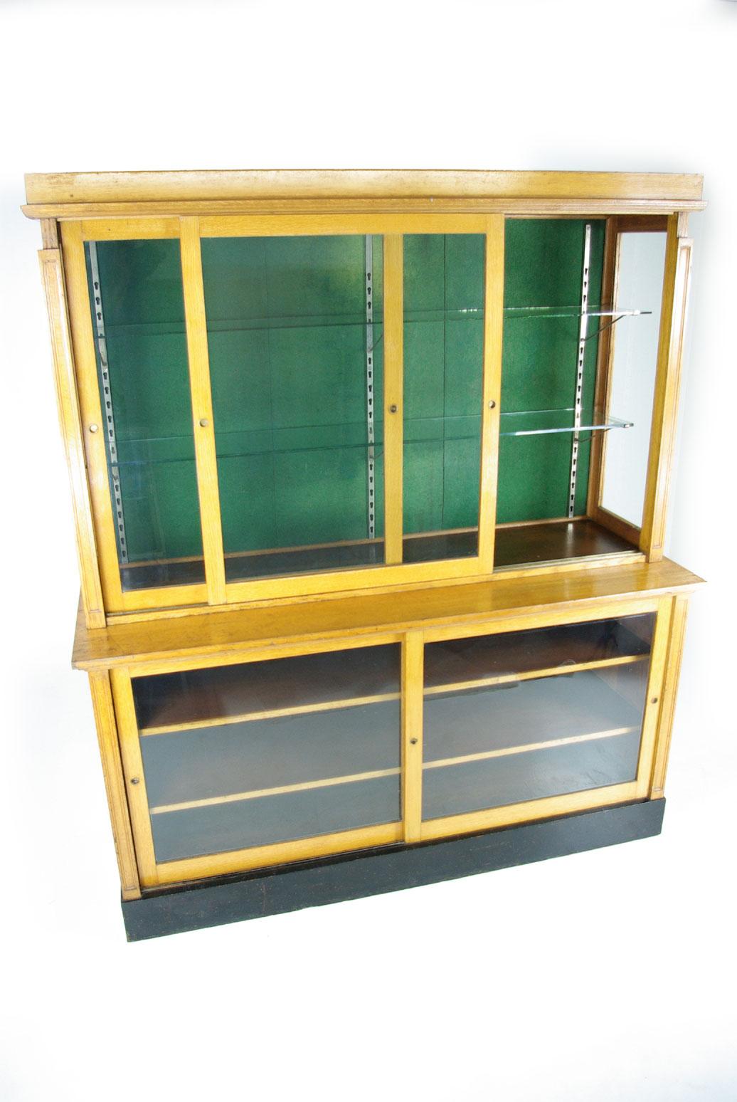 Large oak showcase, country store showcase, China display cabinet, Canada, 1920, Antique Furniture, B398.

Canada, 1920
Solid light oak construction
All original finish
Two sliding glass doors above with plate glass shelves (adjustable).
Two sliding
