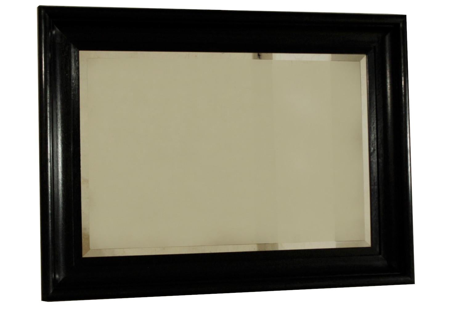 Large faceted mirror with oak frame from the 1930s. It is in very good condition.