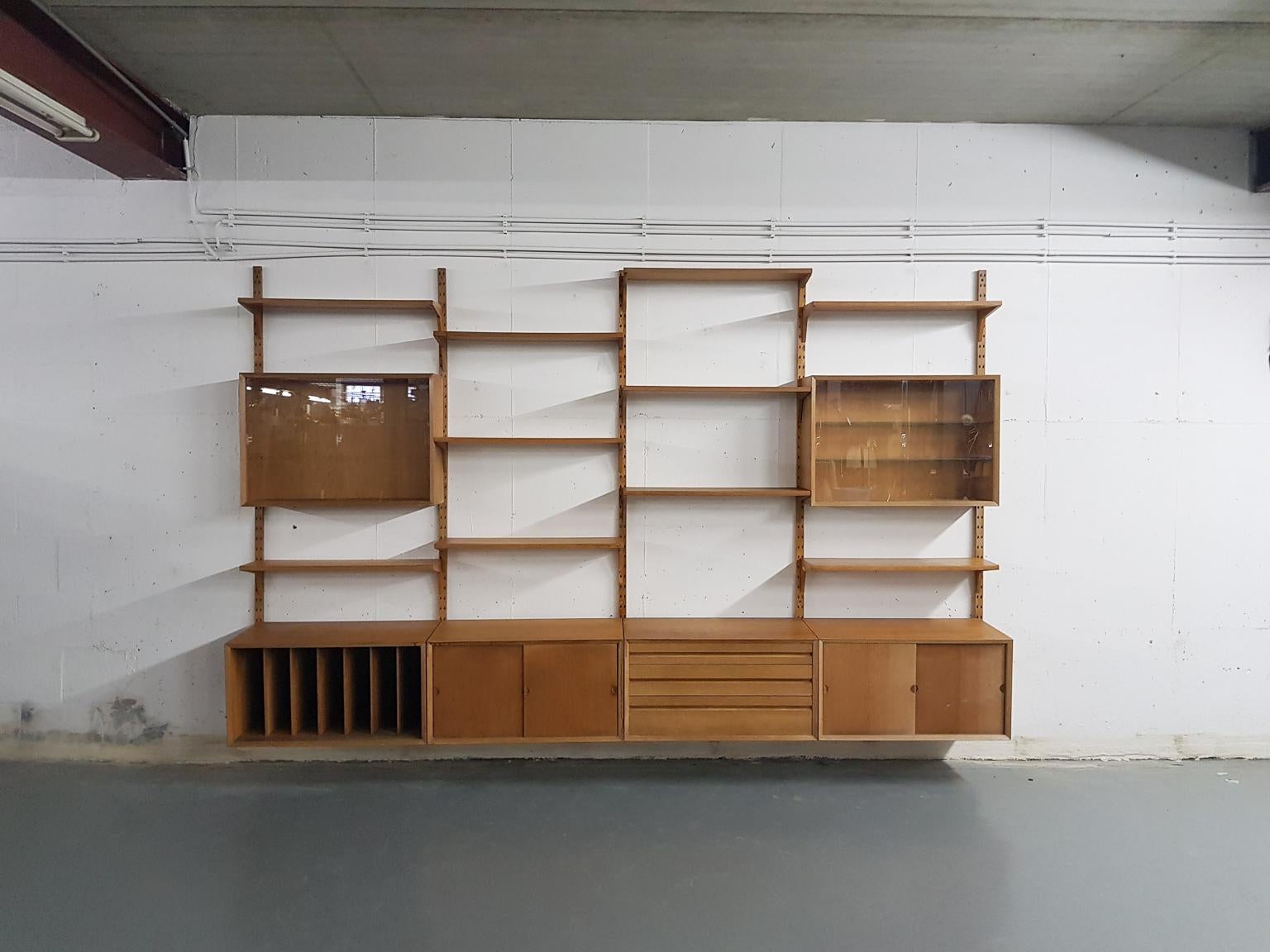 Large Danish design oak wall system or shelving unit by Poul Cadovius for Cado, designed in Denmark in 1964.

When you ask someone to think of an European midcentury wall unit, most will probably think of Poul Cadovius and his shelving system. It