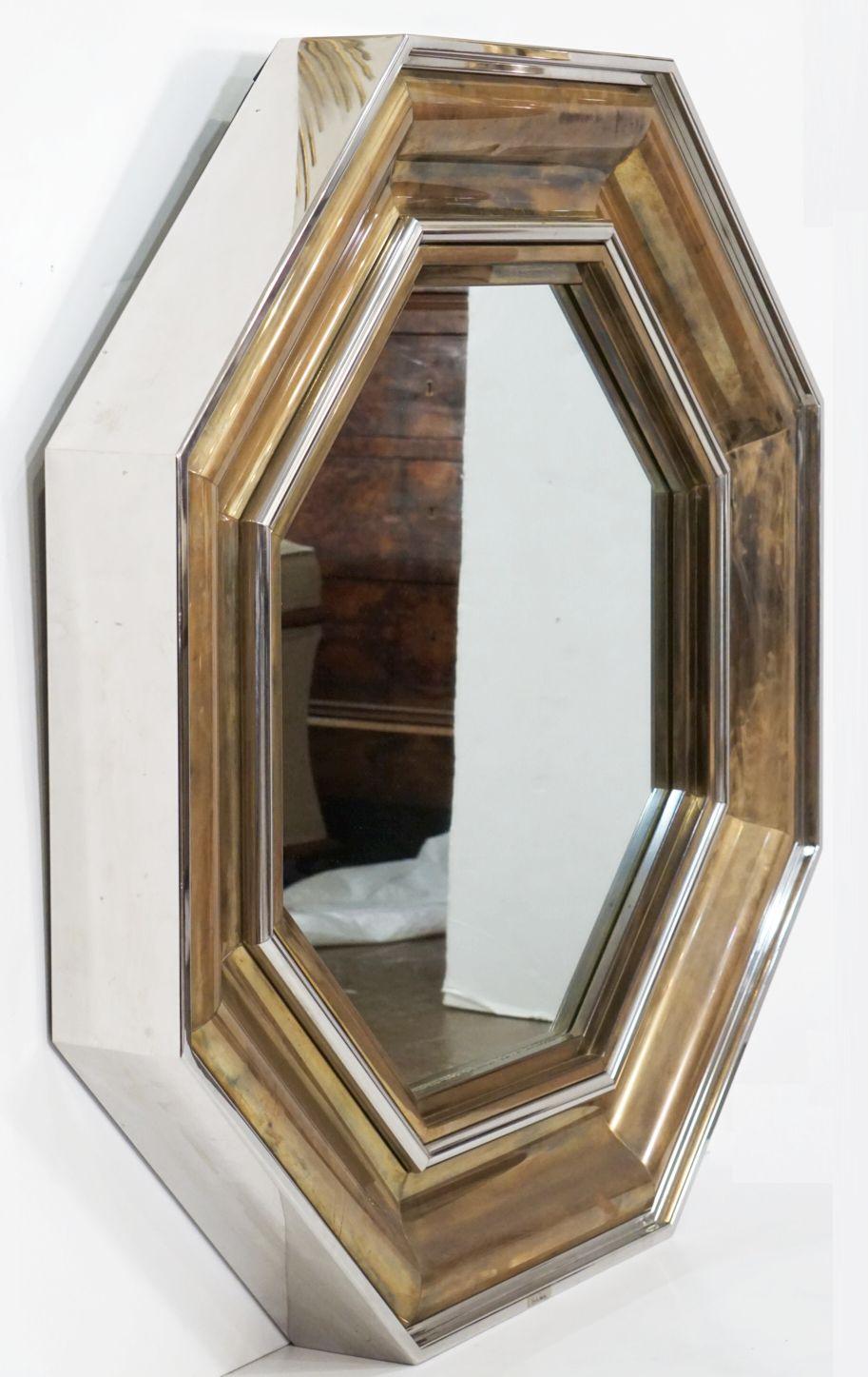 A beautiful large Italian octagonal brass and chrome mirror - designed by the famed Italian architect, Sandro Petti, for the French design house, Maison Jansen, and produced by L'angolo Metallarte, in the 1970s.
The frame featuring stylishly chic