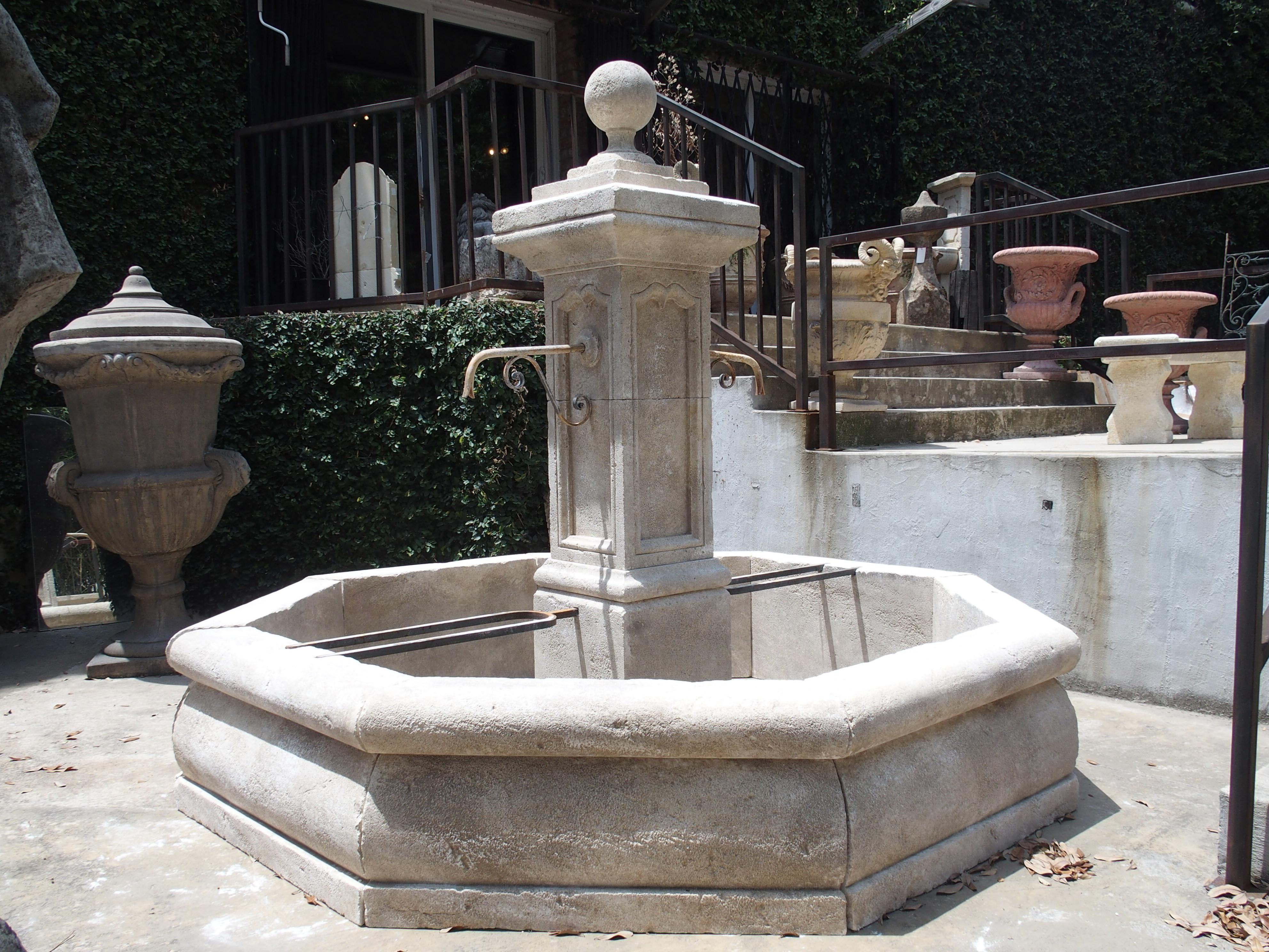 This beautiful French center fountain from Provence has been hand carved and distressed out of Estaillade limestone. The center post has a ball finial, while four sides having recessed panels with stylized ogee moldings. The ball portion can be left