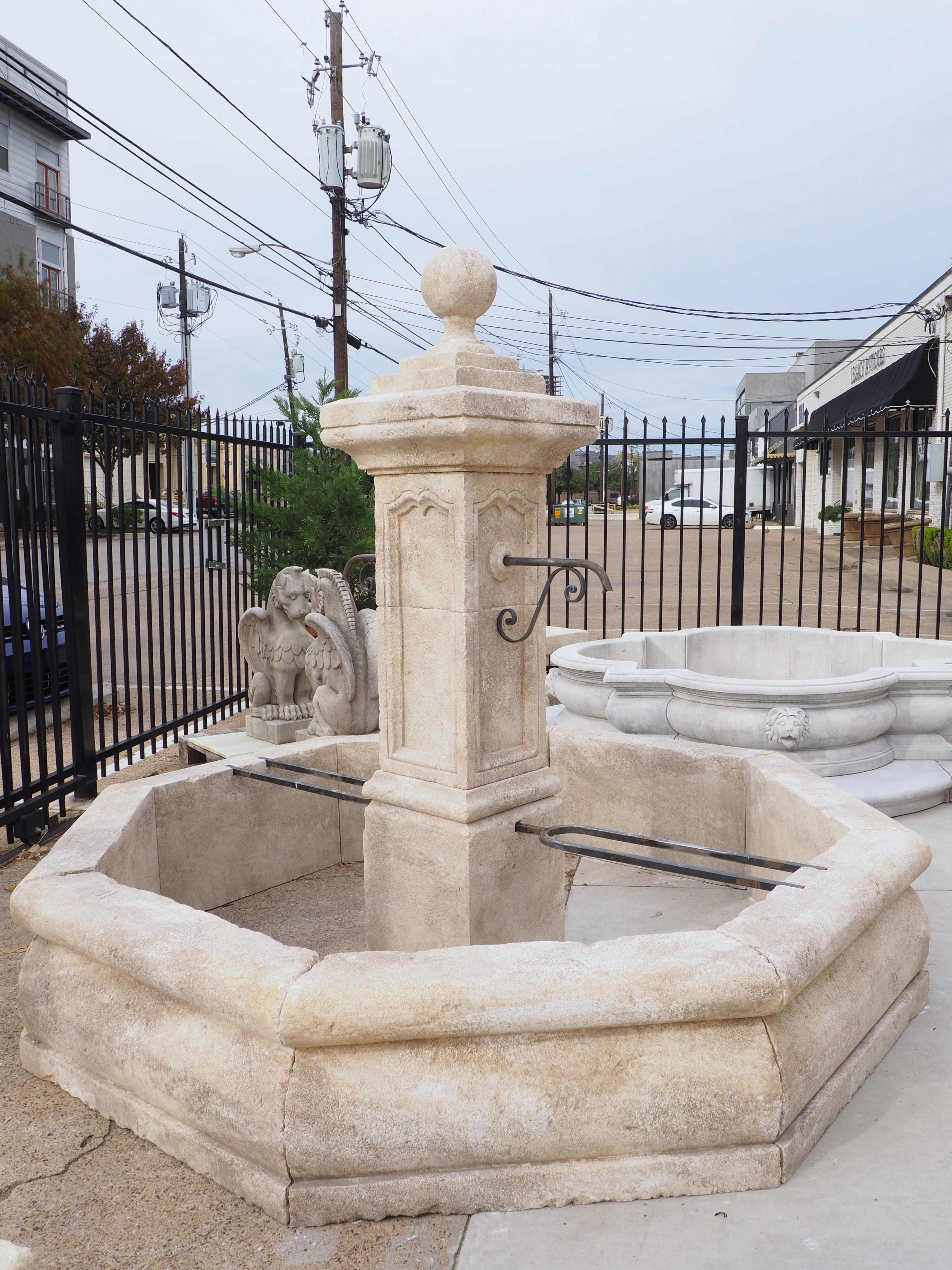 This large octagonal center fountain from Provence has been hand-carved from 15 pieces of Estaillade limestone. The center column has a ball finial on top of a square plinth. Beneath a second, larger plinth is a thick cornice with cavetto molding. A