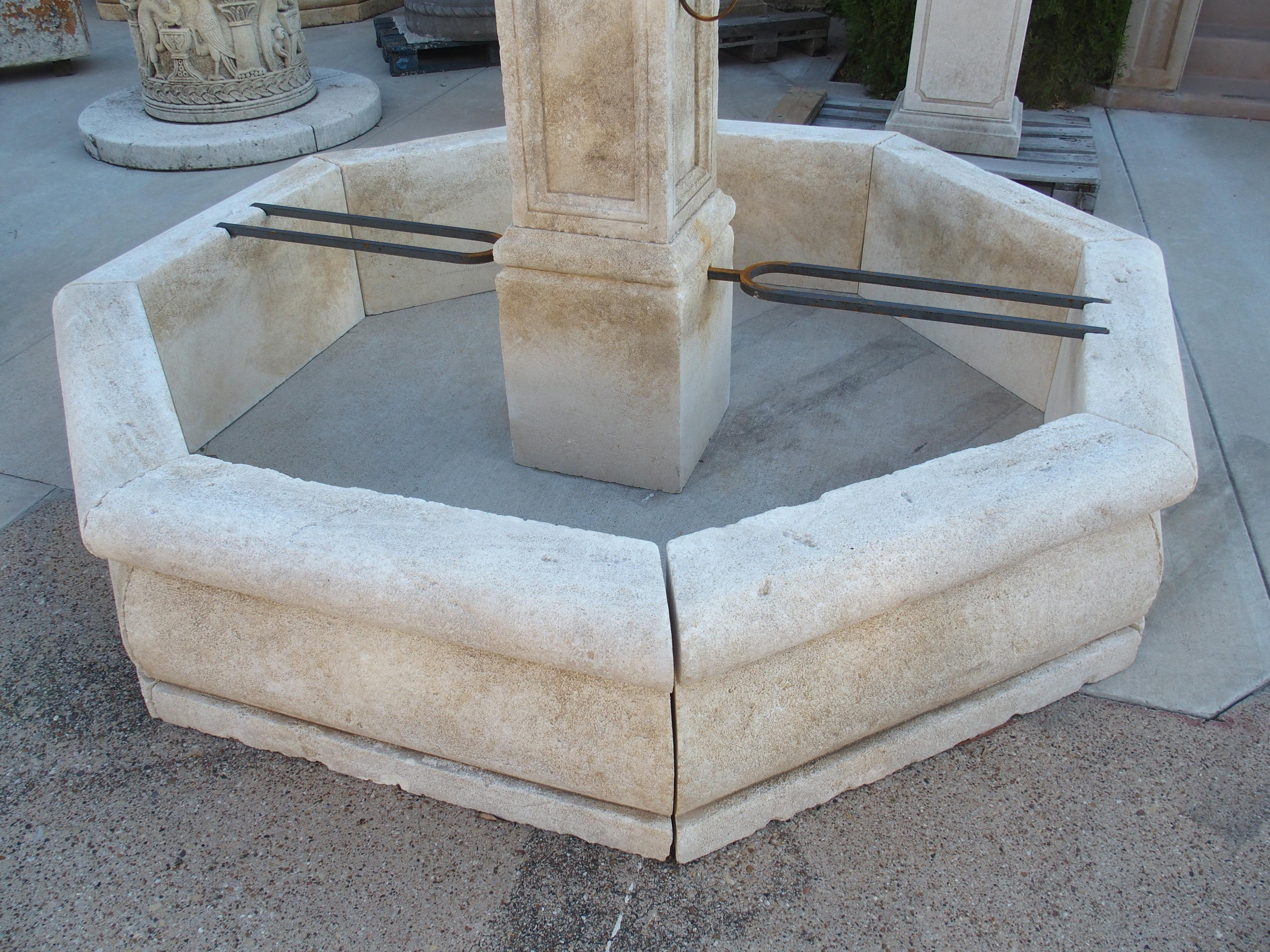 This large octagonal center fountain from Provence has been hand-carved from 15 pieces of Estaillade limestone. The center column has a ball finial on top of a square plinth. Beneath a second, larger plinth is a thick cornice with cavetto molding. A