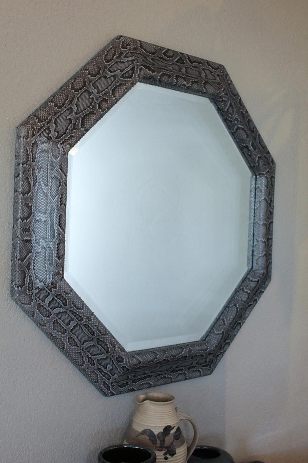 A large 1980s octagonal beveled mirror with genuine python frame in gorgeous shades of grey and dark chocolate.