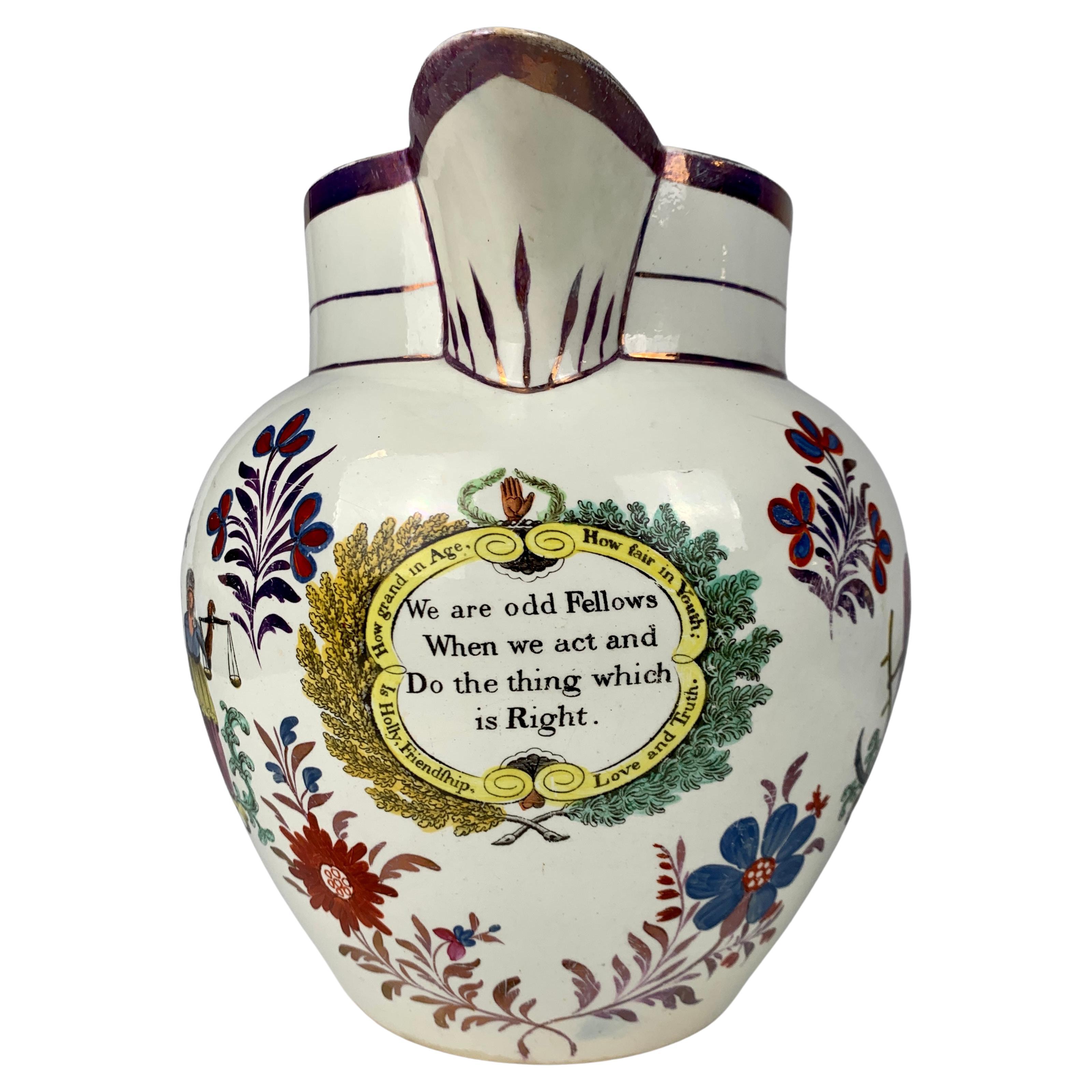 This massive and rare pitcher is fully decorated with the imagery and symbols of the Masons and Odd Fellows (see images). Odd Fellows promote philanthropy, the ethic of reciprocity, and charity. 
At the front of the pitcher, we see a panel with the
