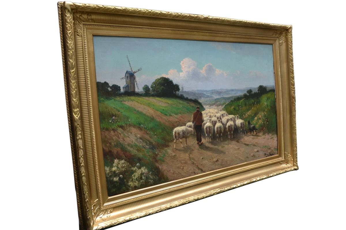 A calming bucolic painting of a shepherd herding his flock of sheep back home at sunset  along a country lane assisted by his sheepdog. The painting  is presented in a gesso carved gilt wooden frame and is signed H. Matthys at the bottom right hand