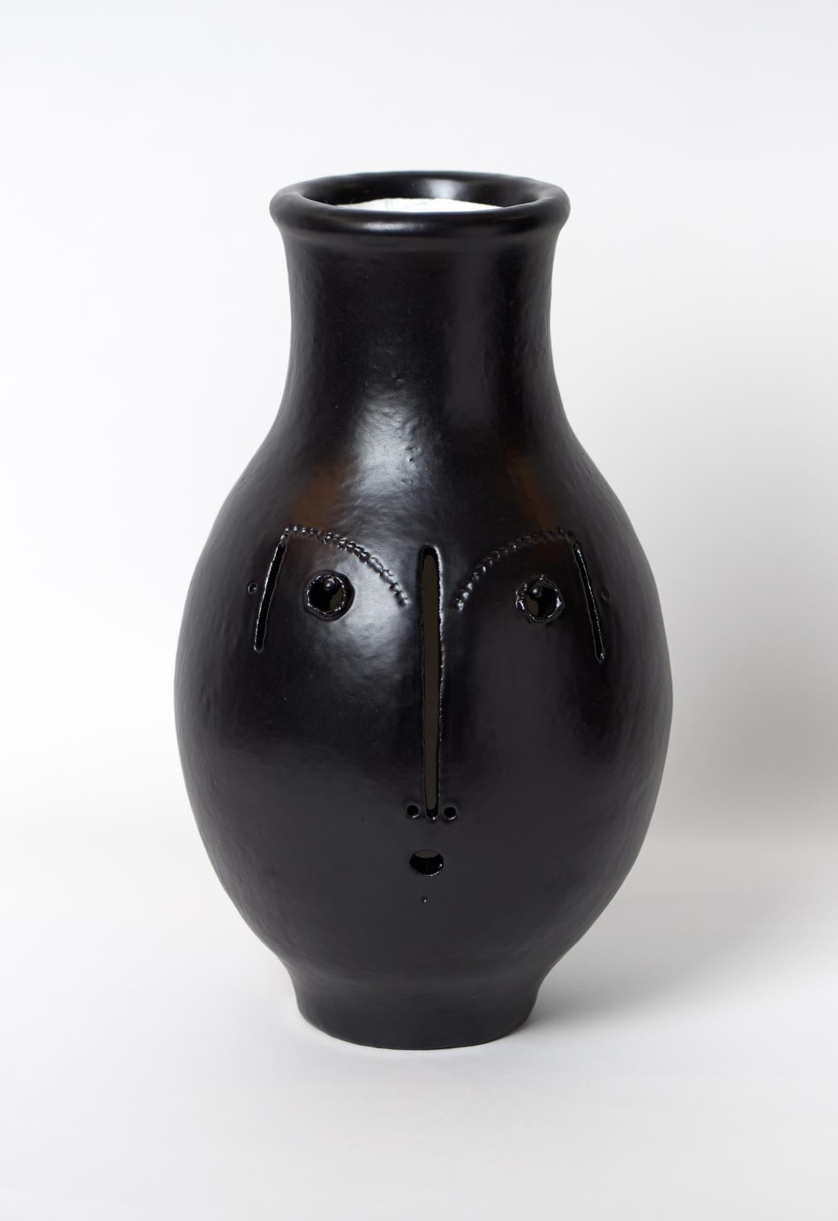 Large hand-sculpted ceramic decorative vase, stylized face with open lines, stoneware glazed in black outside and white enamel inside.

One of a kind handmade piece signed by the French ceramicists Dalo, 2018.

Information: This is a decorative vase