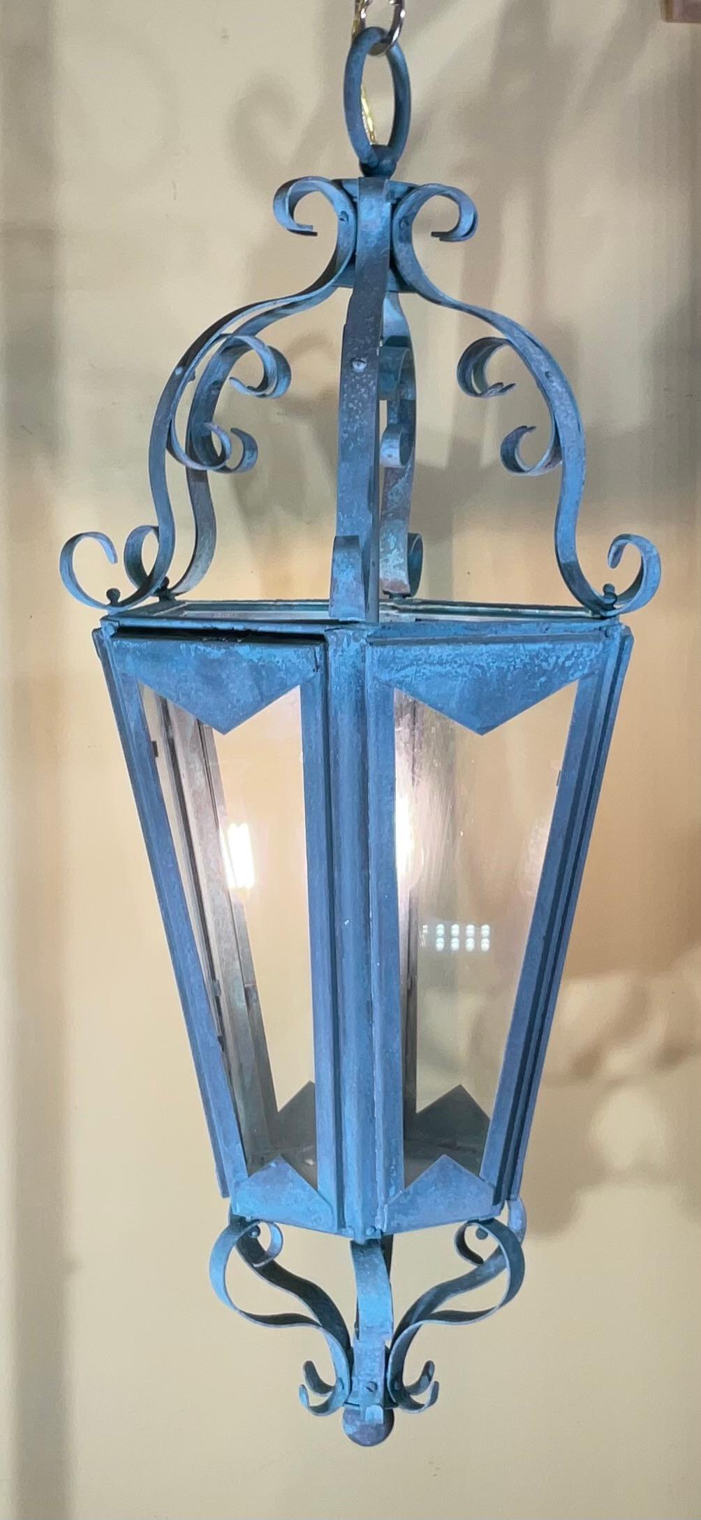 This is a beautiful One Of A King , large antique hanging lantern, crafted from solid copper and brass. The lantern's surface has developed a stunning natural verdigris patina, showcasing its age and authenticity. Its classic design and robust