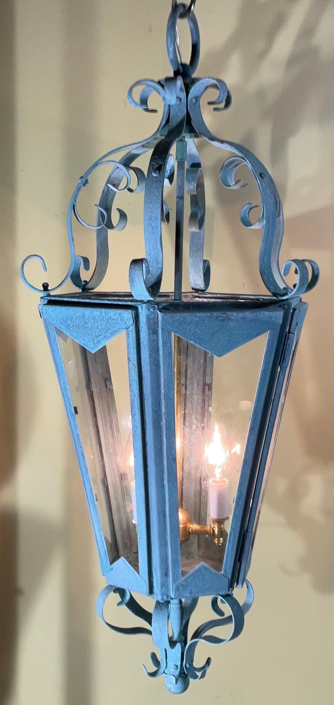 This is a beautiful One Of A King , large antique hanging lantern, crafted from solid copper and brass. The lantern's surface has developed a stunning natural verdigris patina, showcasing its age and authenticity. Its classic design and robust