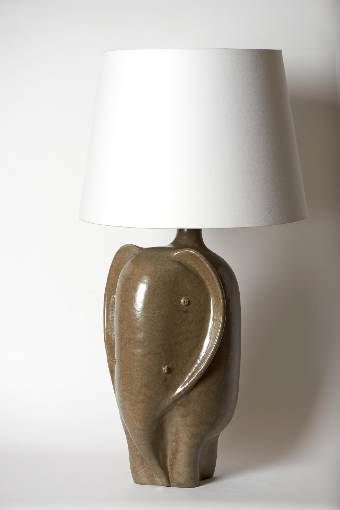 Large hand-sculpted ceramic lamp base, stylized elephant stoneware glazed in Khaki color enamel.
One of a kind handmade piece signed by the French ceramicists Dalo 
The height dimension (57 cm) is for the ceramic sculpture solely
Note to