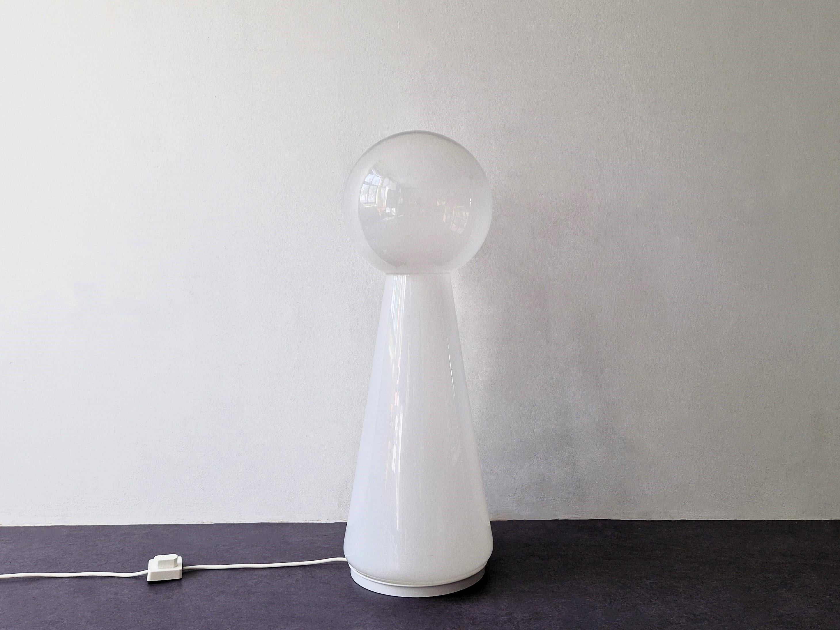 This beautiful geometrically shaped lamp is most likely Italian and hand made/blown out of Murano glass. The lamp goes from a white opal glass base to a clear glass ball at the top, all made out of 1 piece. All together it gives a beautiful light