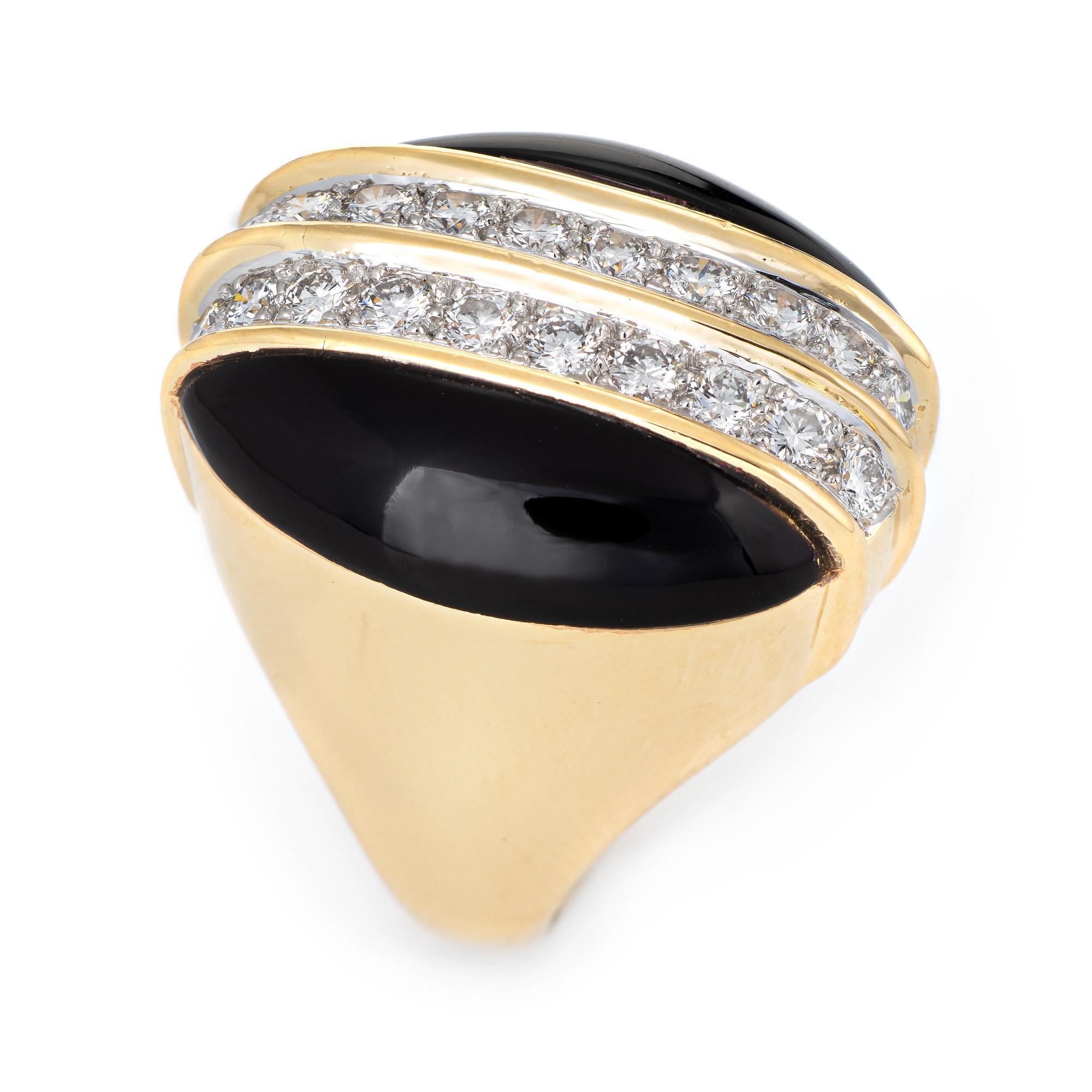 Stylish vintage onyx & diamond cocktail ring (circa 1960s to 1970s) crafted in 18 karat yellow gold. 

Two pieces of onyx each measure 20mm x 6mm. 20 diamonds are estimated at 0.04 carats each and total an estimated 0.80 carats (estimated at G-H