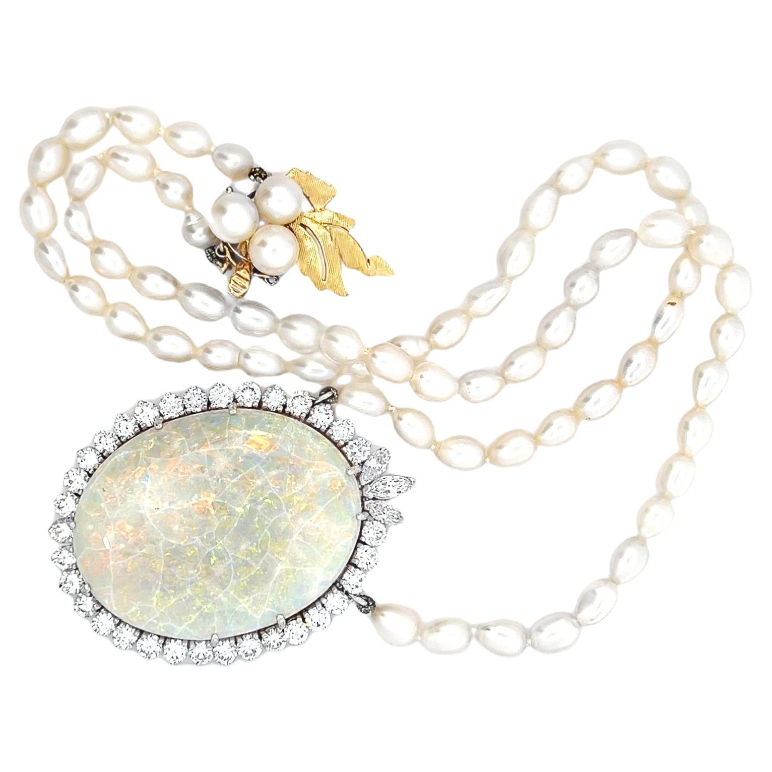 This exquisite necklace is a stunning blend of elegance and craftsmanship, featuring a large opal pendant surrounded by a halo of 2.25 carats of sparkling white diamonds. The opal showcases a mesmerizing play of iridescent hues, creating a