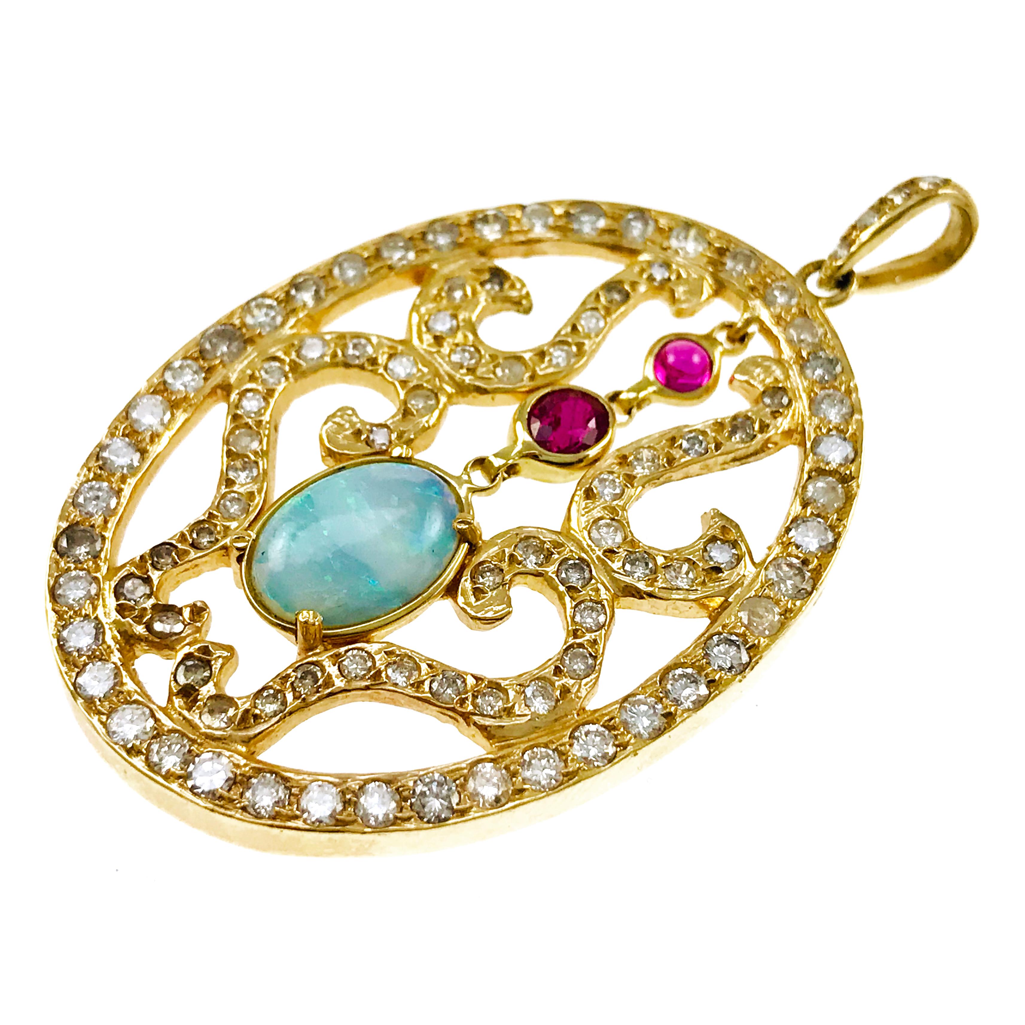 Large Opal Ruby Diamond Pendant. Oval Opal and Round Rubies are the stars of this dazzling pendant. The Opal is 10x7mm, faceted Ruby is 4.x3 mm and Ruby cabochon is 2.5 mm. Swirls of gold frame the gemstones and a sparkling oval of diamonds surround