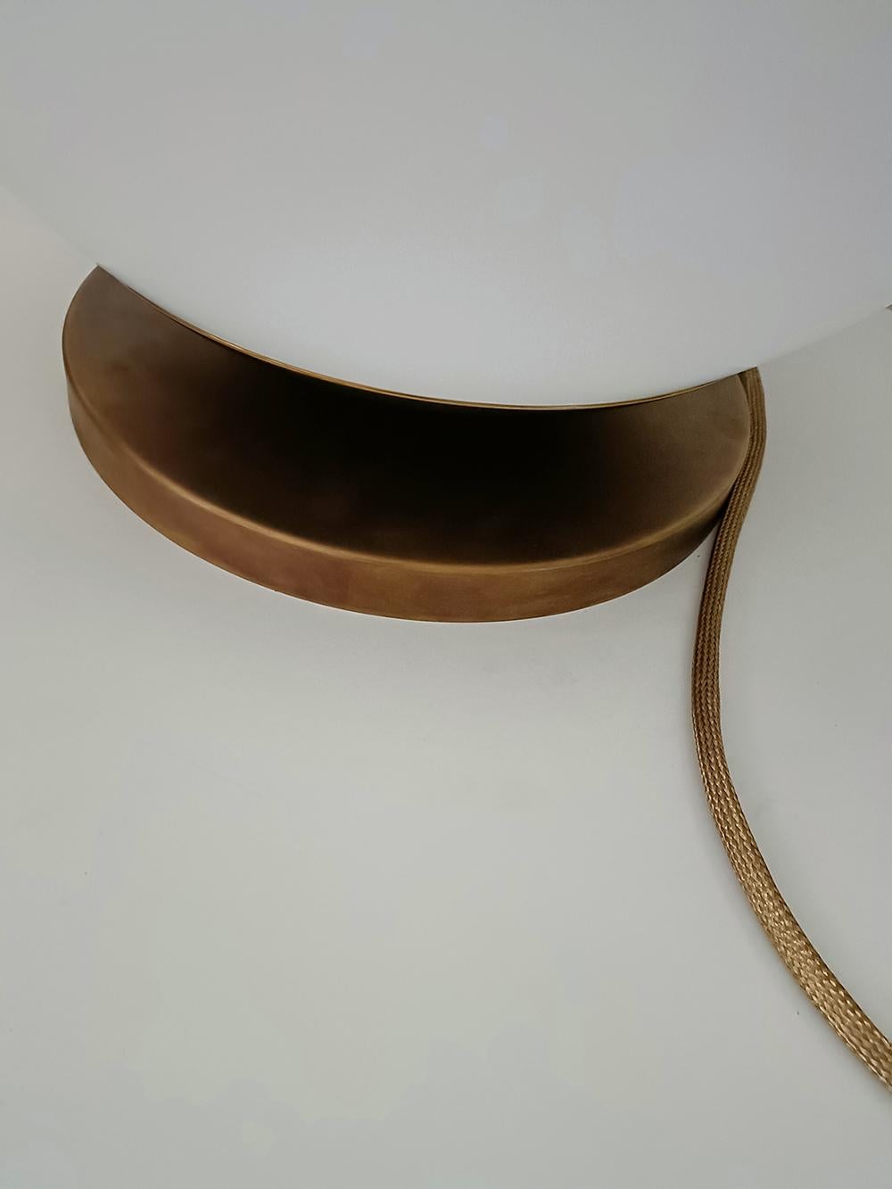 Large (50cm) table lamp in Italian opaline matte glass on the solid brass base (bronze patina). Can be used also as floor lamp.
2m (or longer) cable covered with solid brass sleeve.

Diameter: 50 cm
Height: 54cm

Lamping: E26/E27.

Versions with /