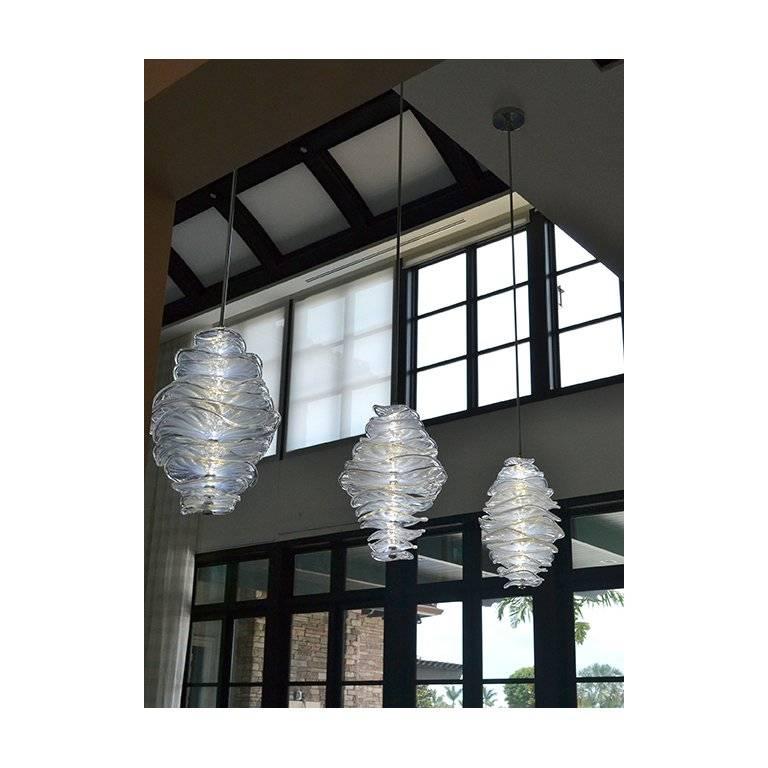 Undulating handblown glass discs stack upon each other on a column of internal illumination, creating a sculptural yet organic form. Canopy with 8