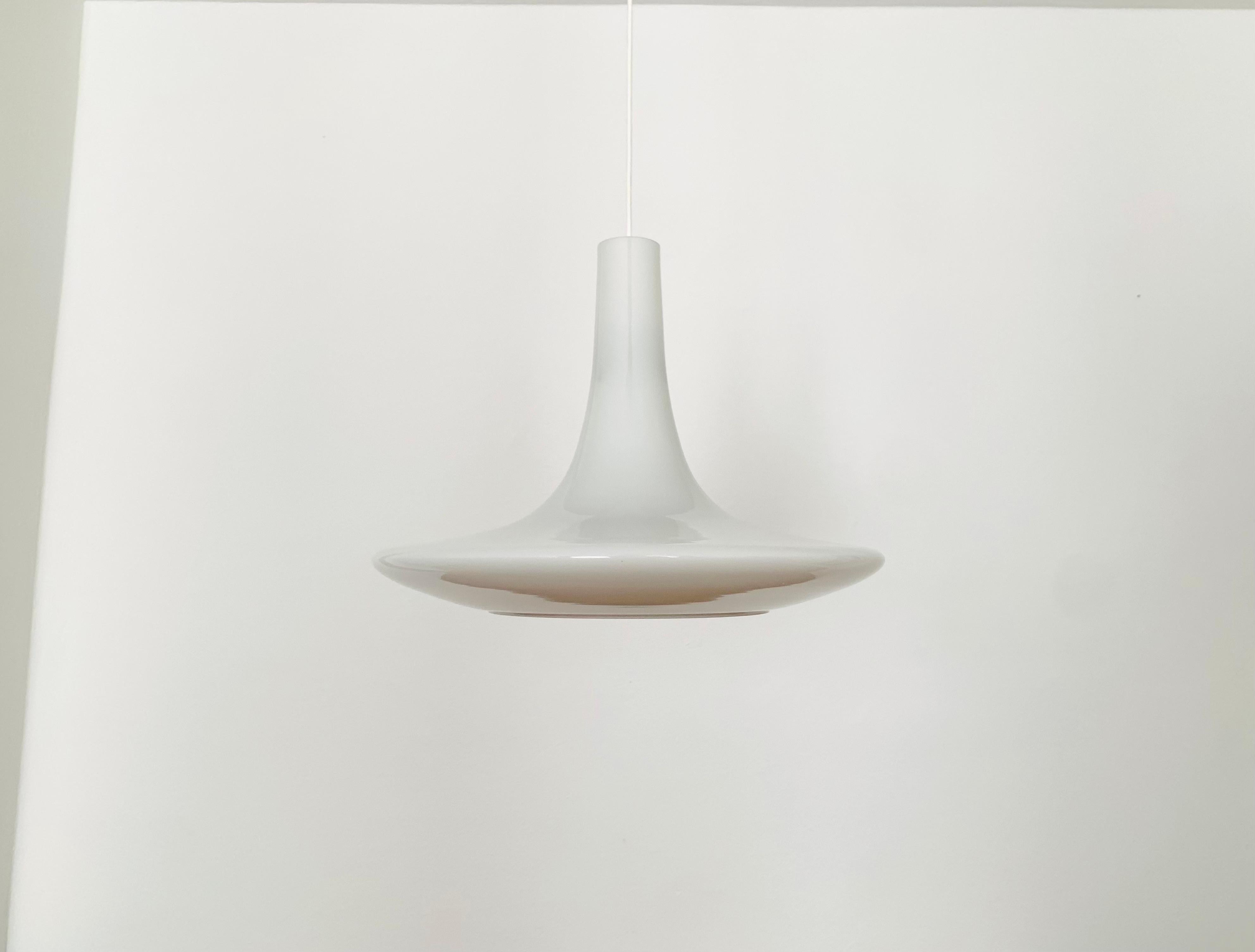 Wonderful opal glass pendant lamp from the 1960s.
Beautiful contemporary design.
The lamp spreads an extremely beautiful lighting atmosphere.

Manufacturer: Peill and Putzler

Condition:

Very good vintage condition with slight signs of wear