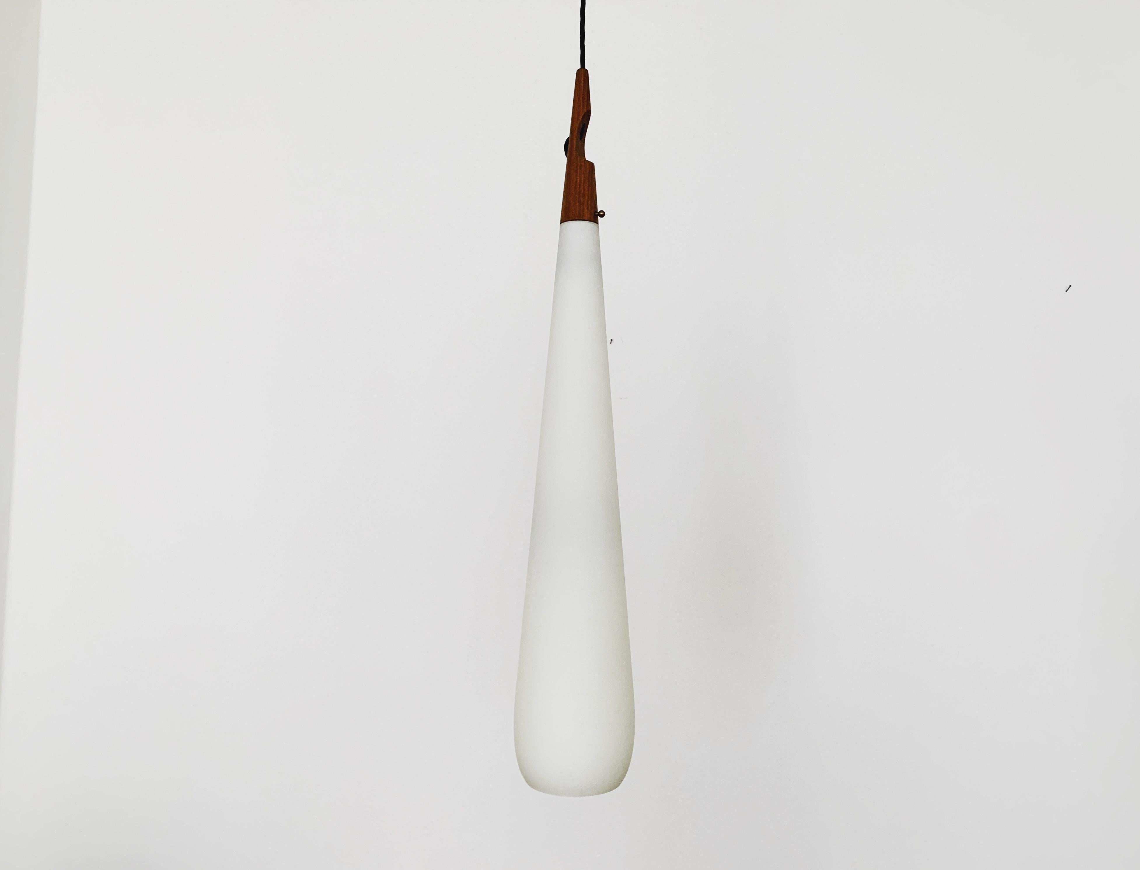 Extremely rare and beautiful Swedish opal glass pendant lamp from the 1960s.
Great and exceptionally minimalistic design with a fantastically elegant look.
Very nice teak details.

Design: Uno and Östen Kristiansson

Condition:

Very good vintage