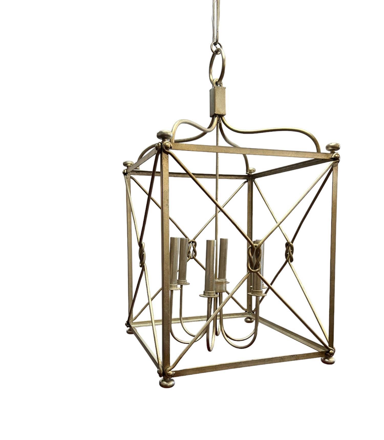 A large open-framed cage-style six-light pendant chandelier finished in a muted/antiqued silver tone. With six lights suspended from a center pole within the open-framed construction, the chandelier will provide ample illumination to brighten any