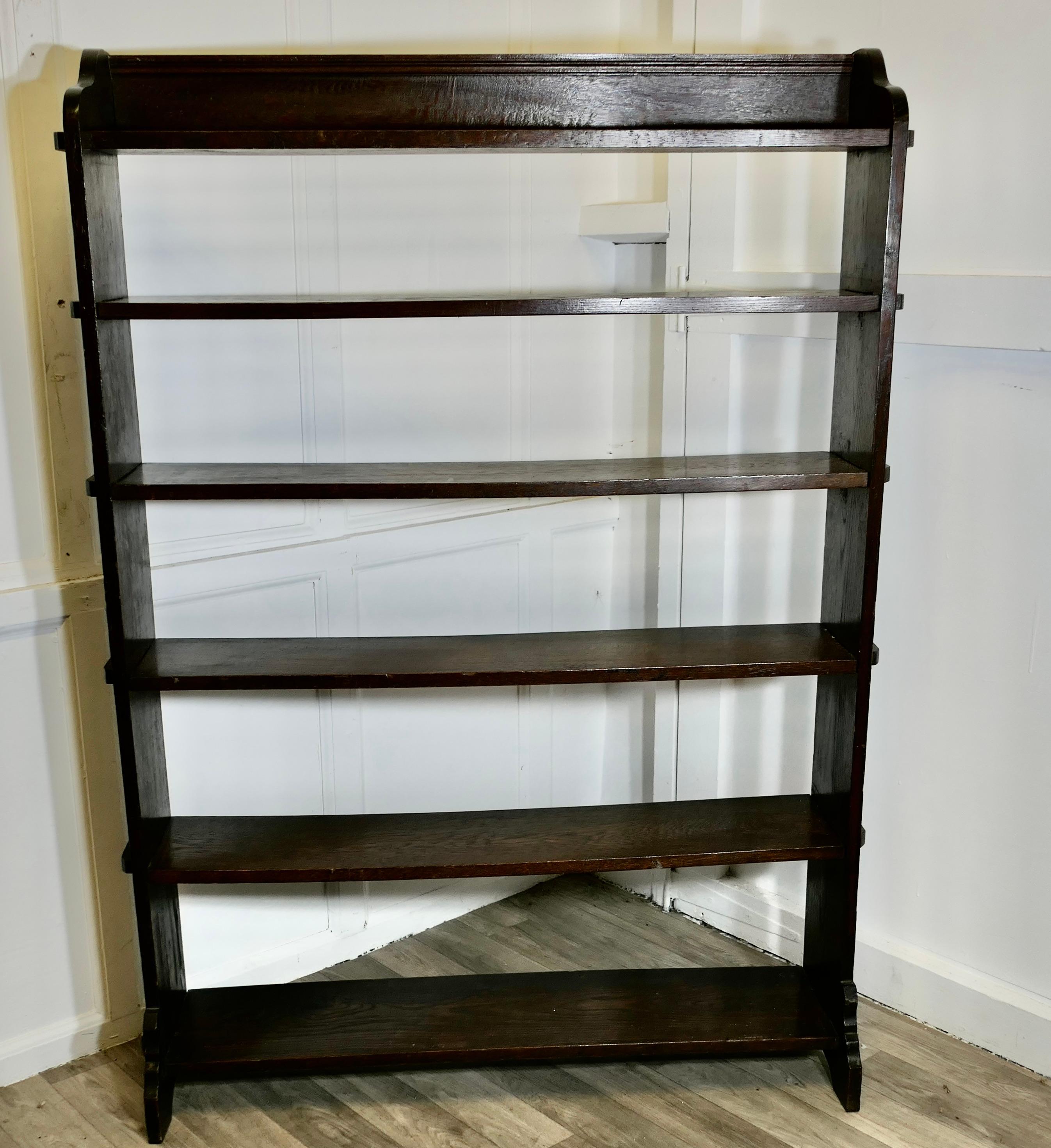 Large Open Front Arts and Crafts Oak Bookcase.

This Oak bookcase has 6 open shelves at varying heights and there is a gallery at the top, all the edges of the bookcase are pegged in the arts an crafts style
The bookcase is in good attractive sturdy