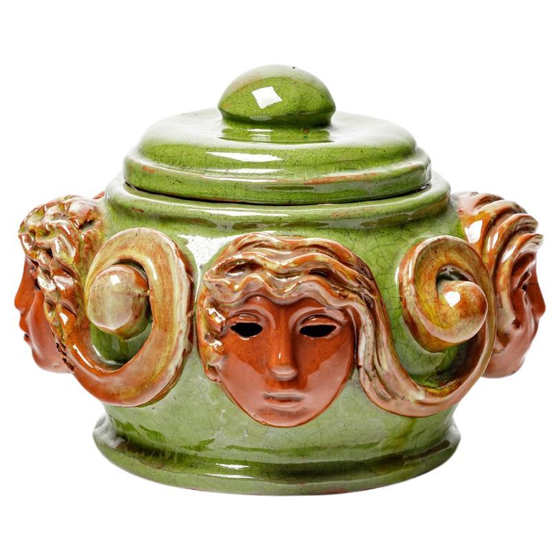 Large orange and green visages art deco decorative box att. to Paul Pouchol